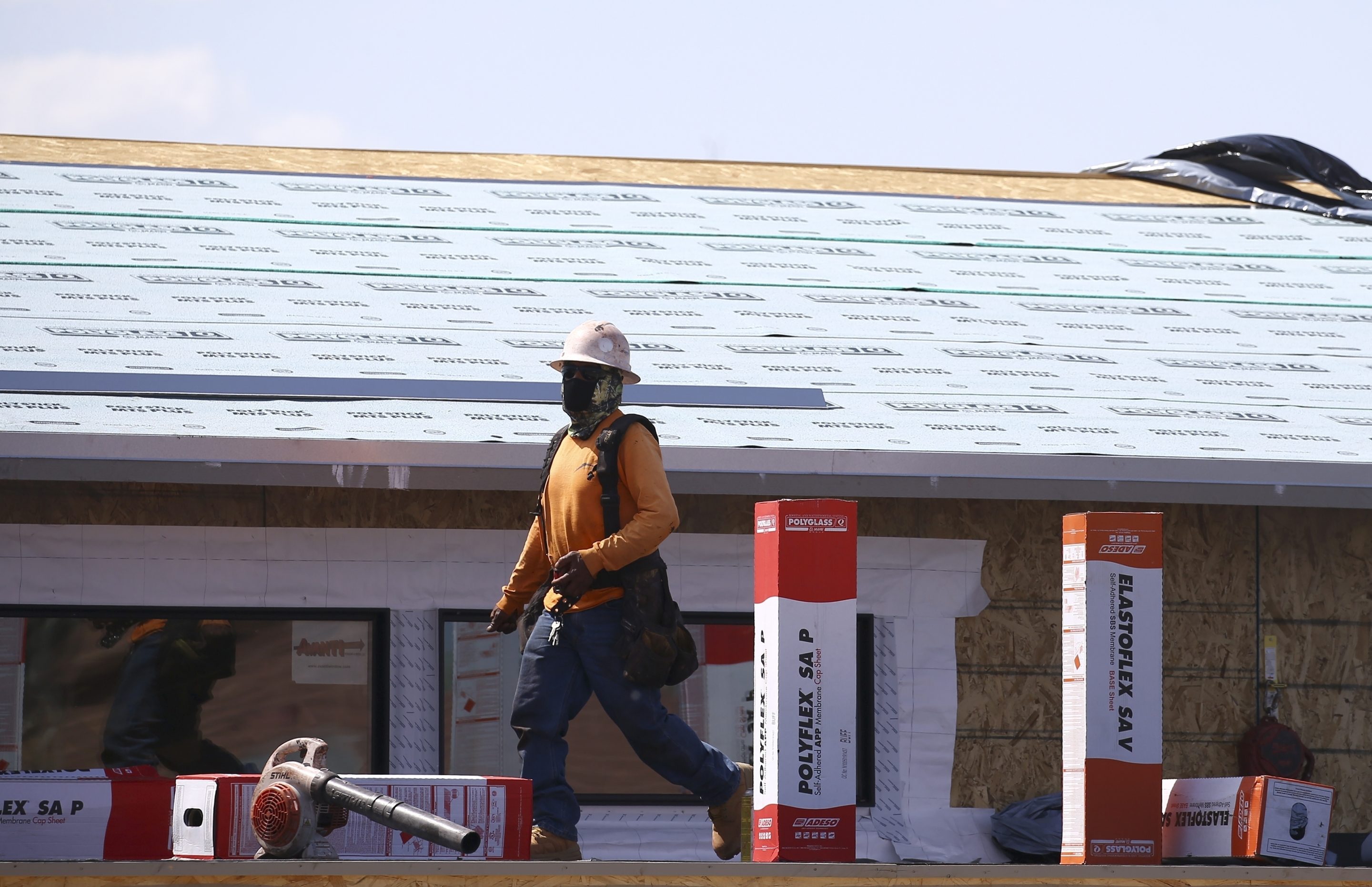 A construction worker continues building at a large housing development, April 21, 2020, in Phoenix.