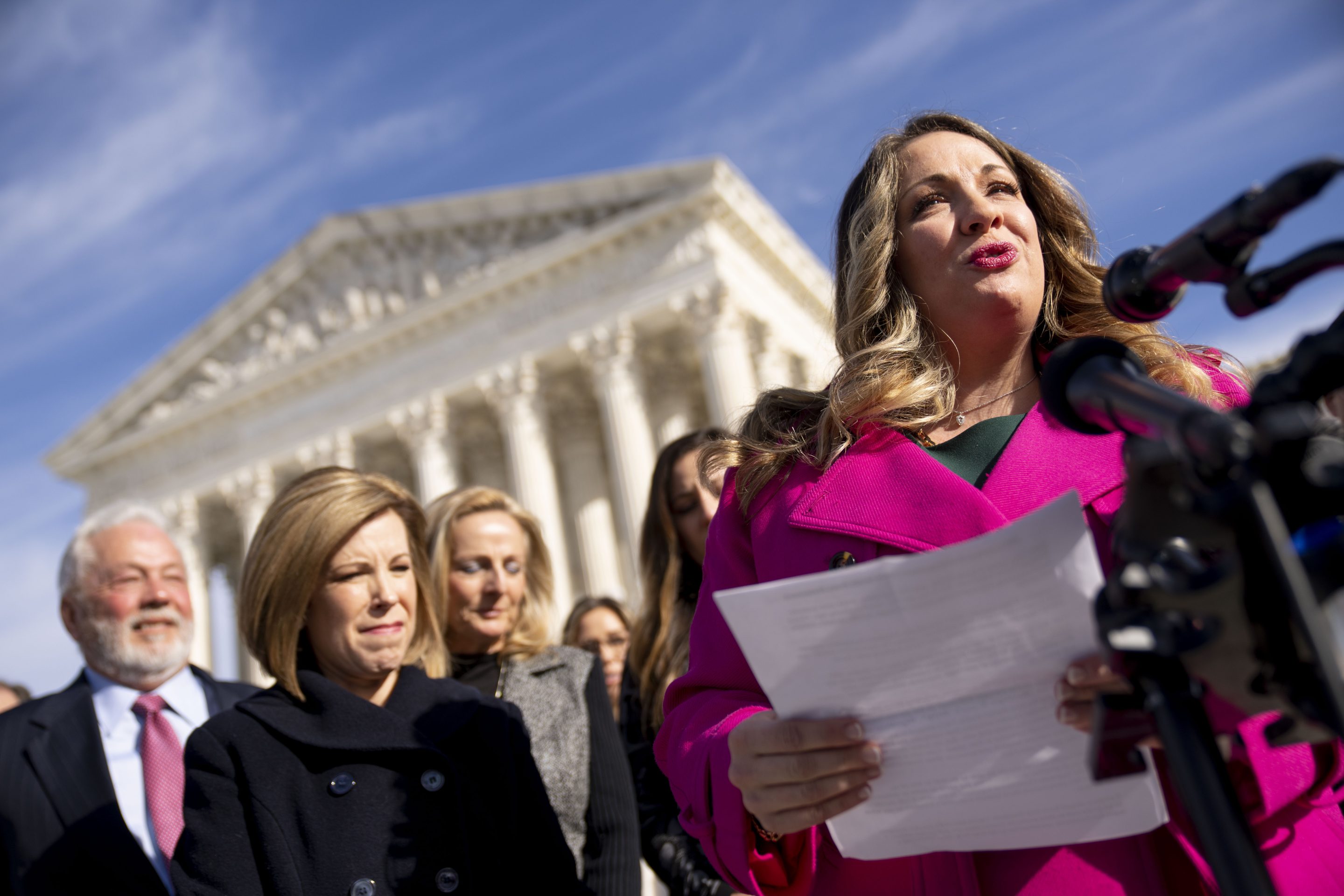 Lorie Smith, a Christian graphic artist and website designer in Colorado, right, speaks outside the Supreme Court in Washington on Dec. 5, 2022. The Supreme Court is hearing the case of Smith, who objects to designing wedding websites for gay couples.