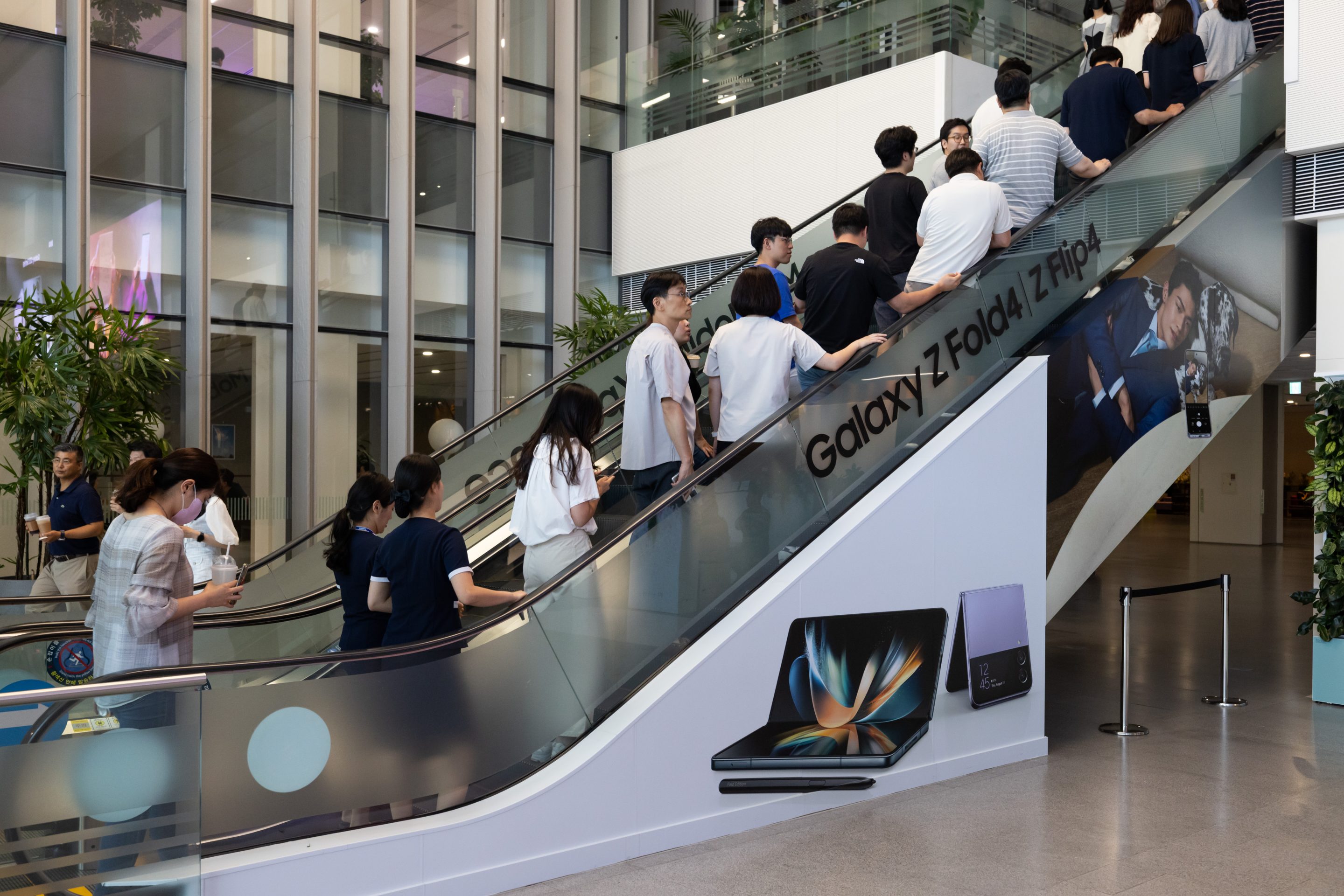Employees ride an escalator at the Samsung Electronics Co. headquarters in Suwon, South Korea, on June 13, 2023.