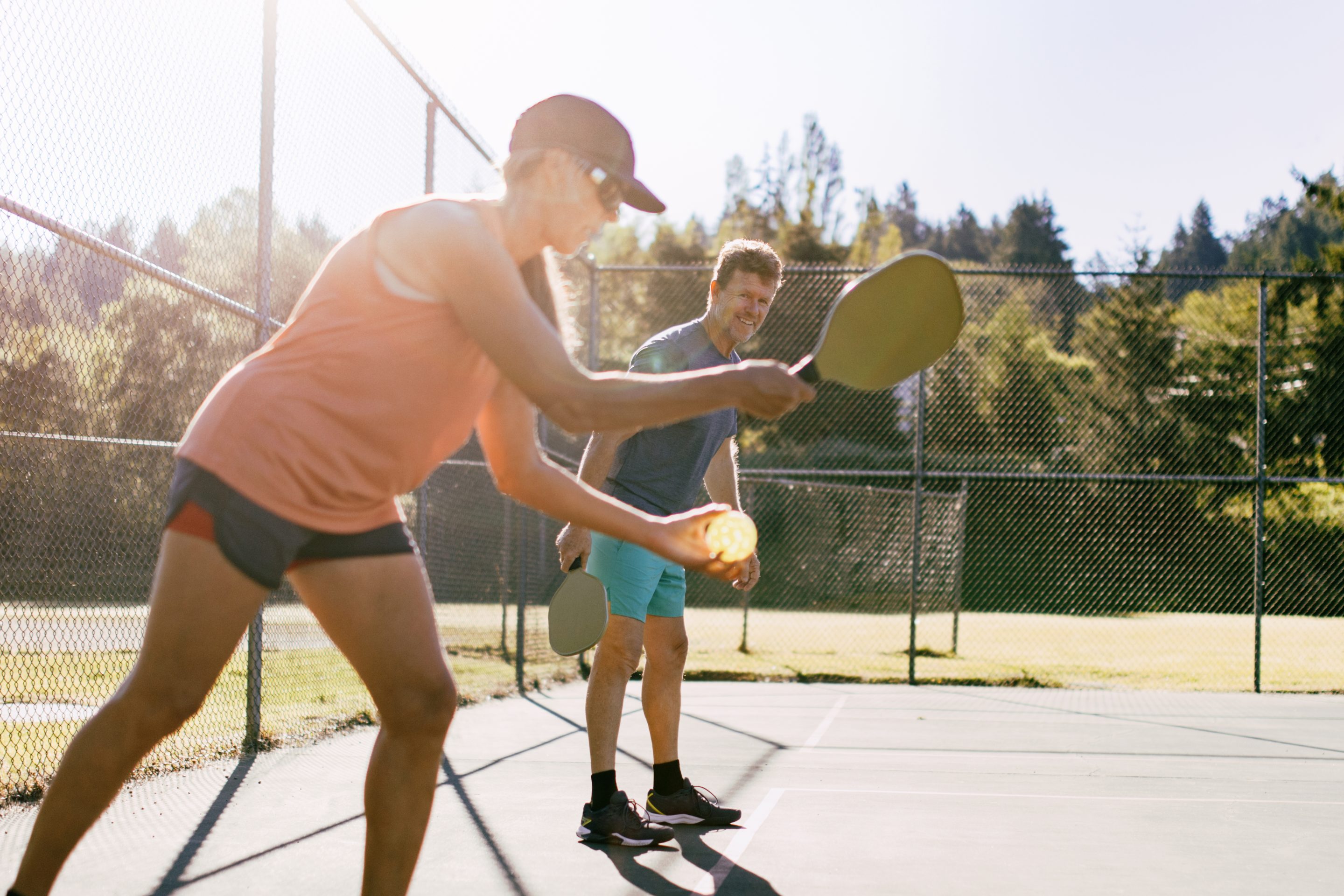 A couple enjoys pickleball.