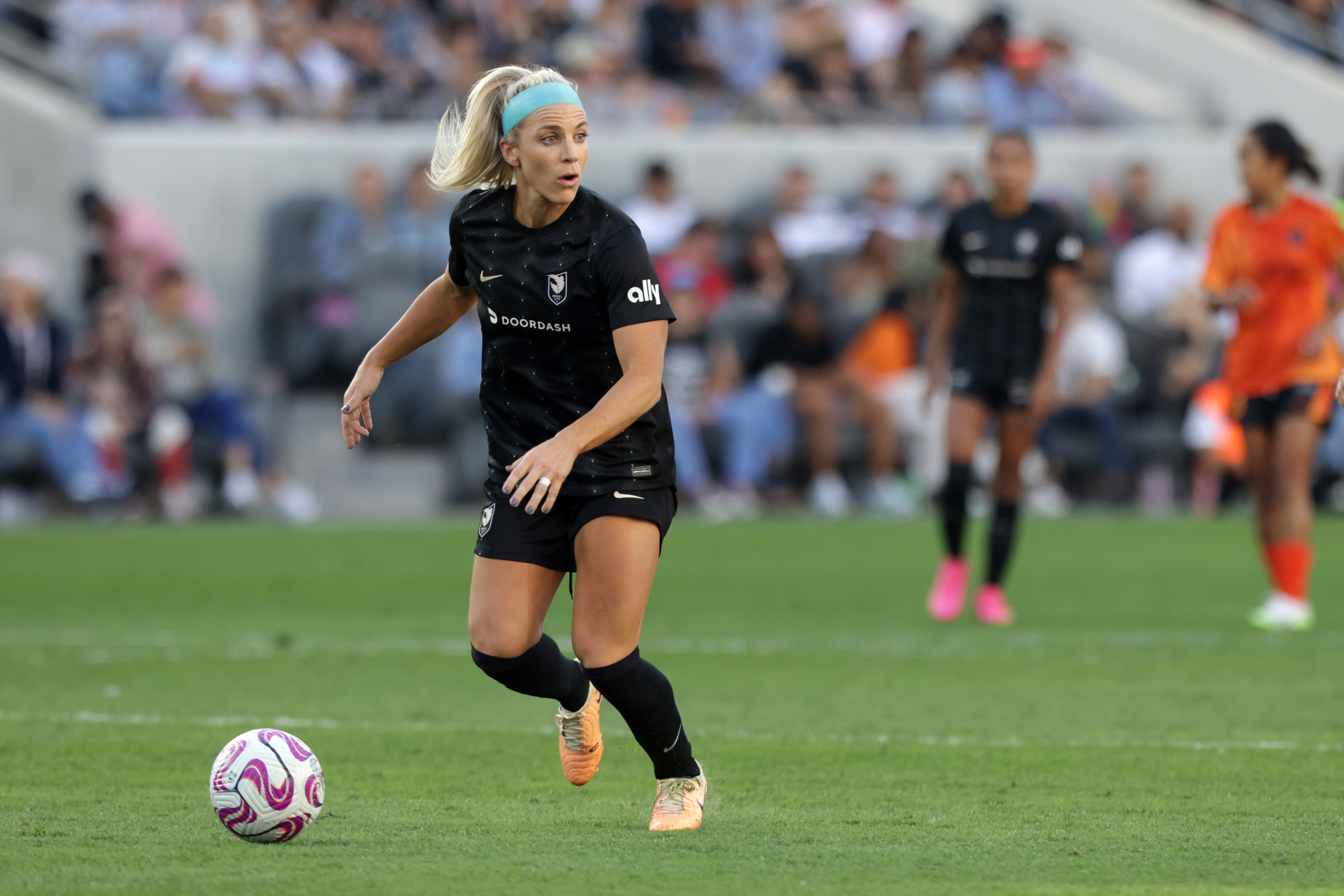 Julie Ertz #8 of Angel City FC looks to pass during the second half of a game against the Houston Dash at BMO Stadium on June 25, 2023 in Los Angeles, California.