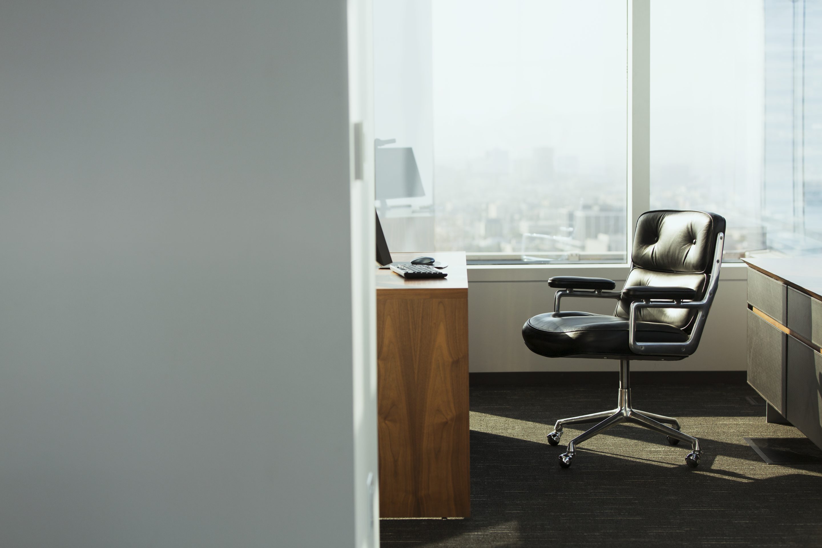 An empty chair in a corner office.