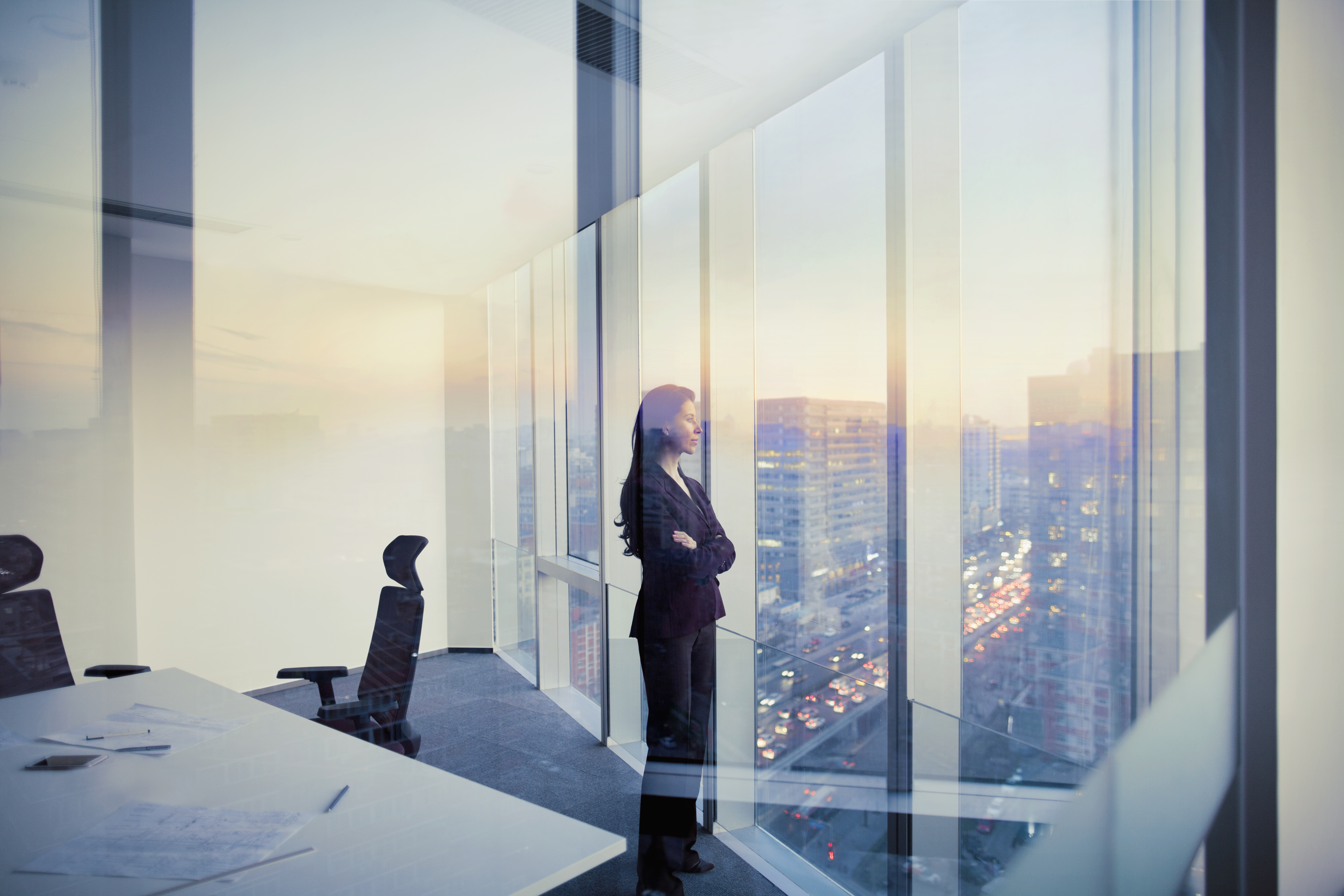 Adult Hispanic woman CEO executive businesswoman business person in conference meeting room in contemporary modern office daylight sunset dusk talking planning thinking strategy well dressed suit diversity multi-ethnic problems solutions unity cityscape downtown urban new beginnings breaking new ground decisions choices the way forward contemplation vision focus choices decisions solitude quiet alone