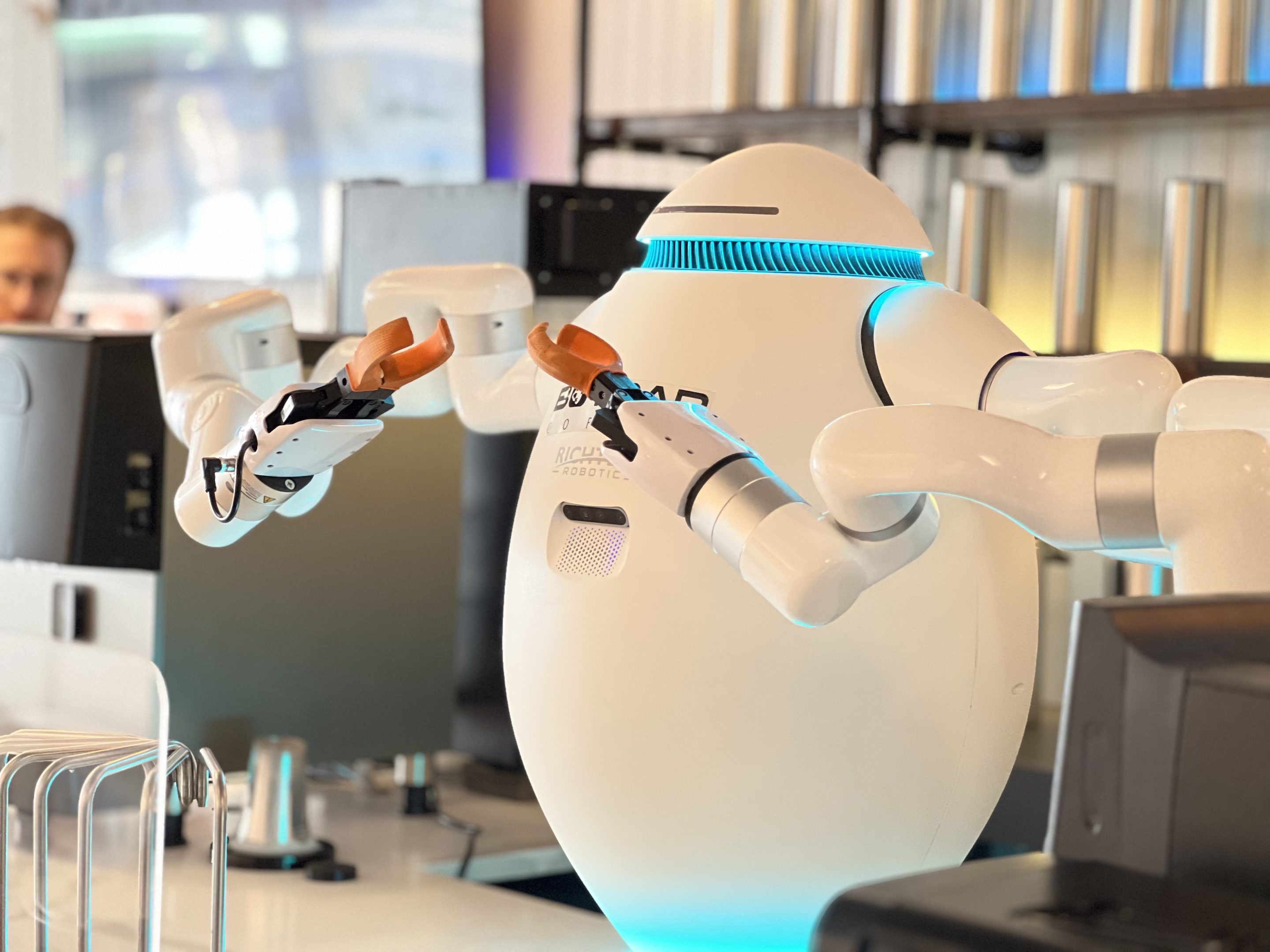 White robot sits on counter at BarBot Coffee