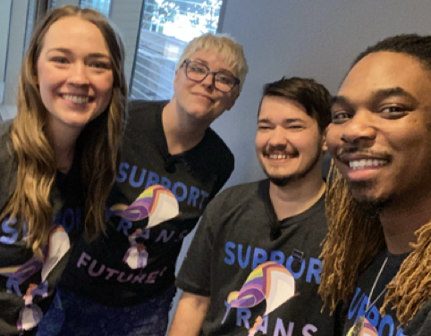 Photo of four smiling people