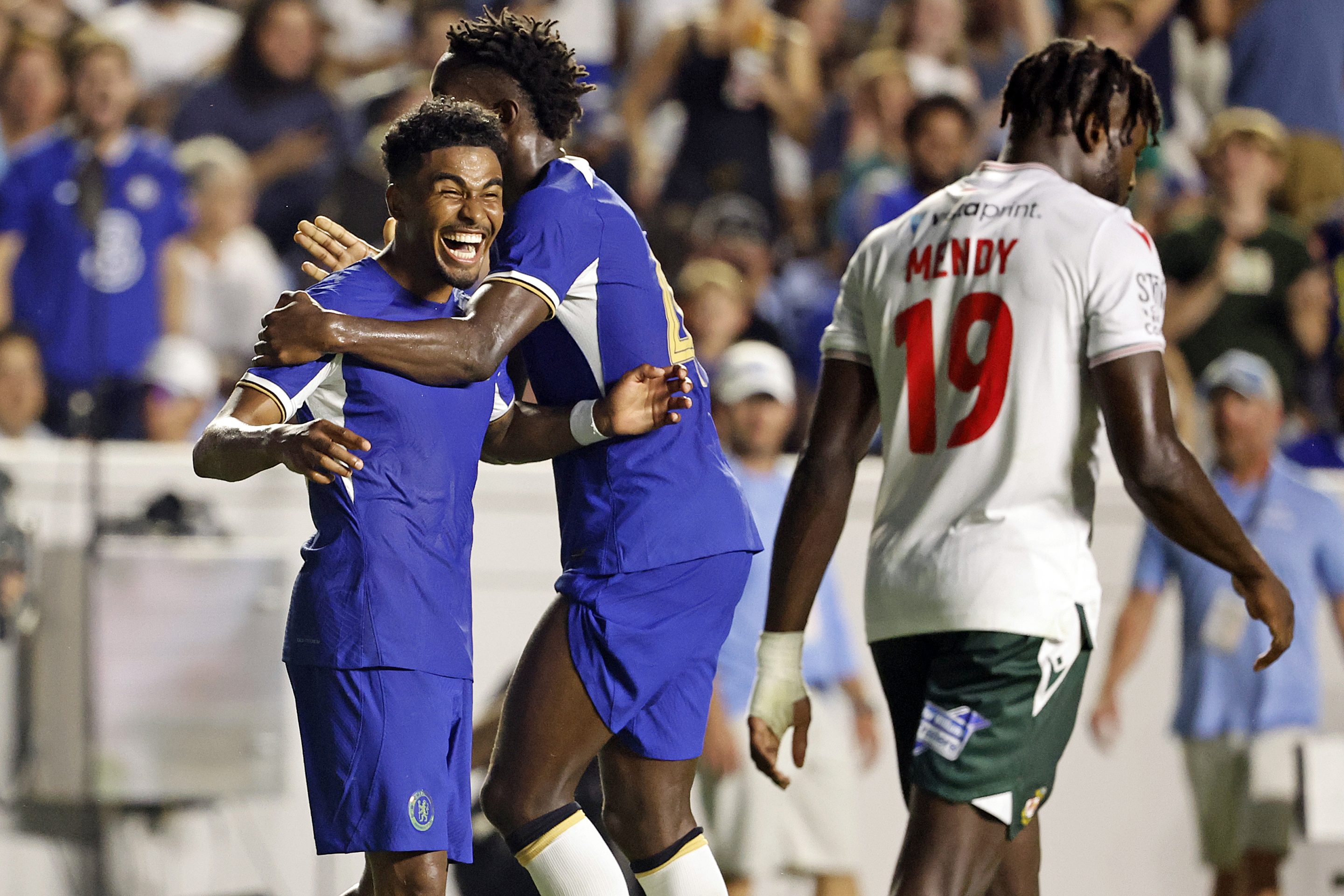 Chelsea's Ian Maatson, left, celebrates a goal with Nicolas Jackson, center, while Wrexham's Jacob Mendy (19) walks past during the first half of a club friendly soccer match on July 19, 2023, in Chapel Hill, N.C. 