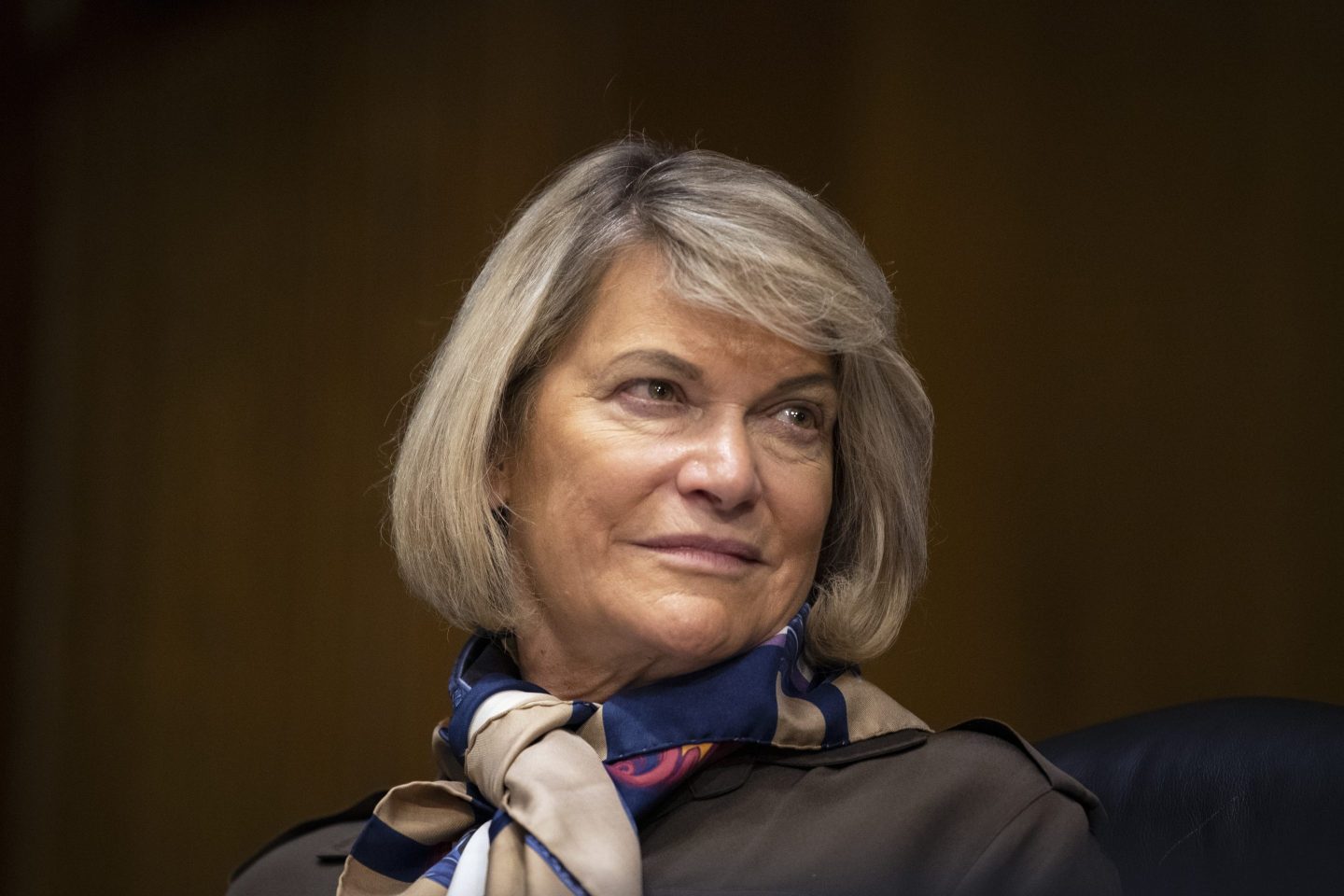Blonde woman wearing silk scarf