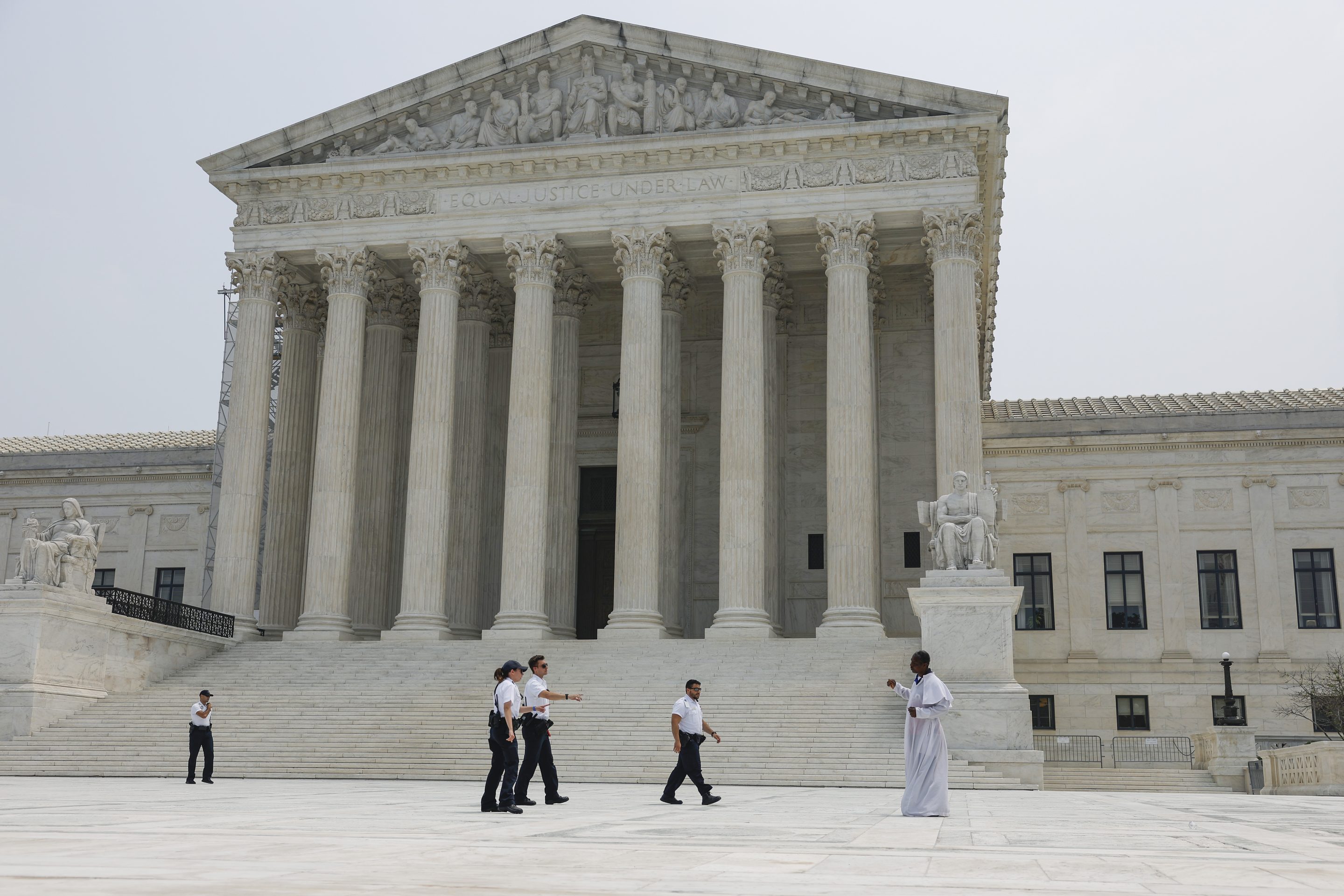 Police officers with the U.S. Supreme Court detain a man who entered the closed front plaza of the Supreme Court on Jun. 29. In a 6-3 vote, Supreme Court Justices ruled that race-conscious admissions programs at Harvard and the University of North Carolina are unconstitutional, setting precedent for affirmative action in other universities and colleges. 