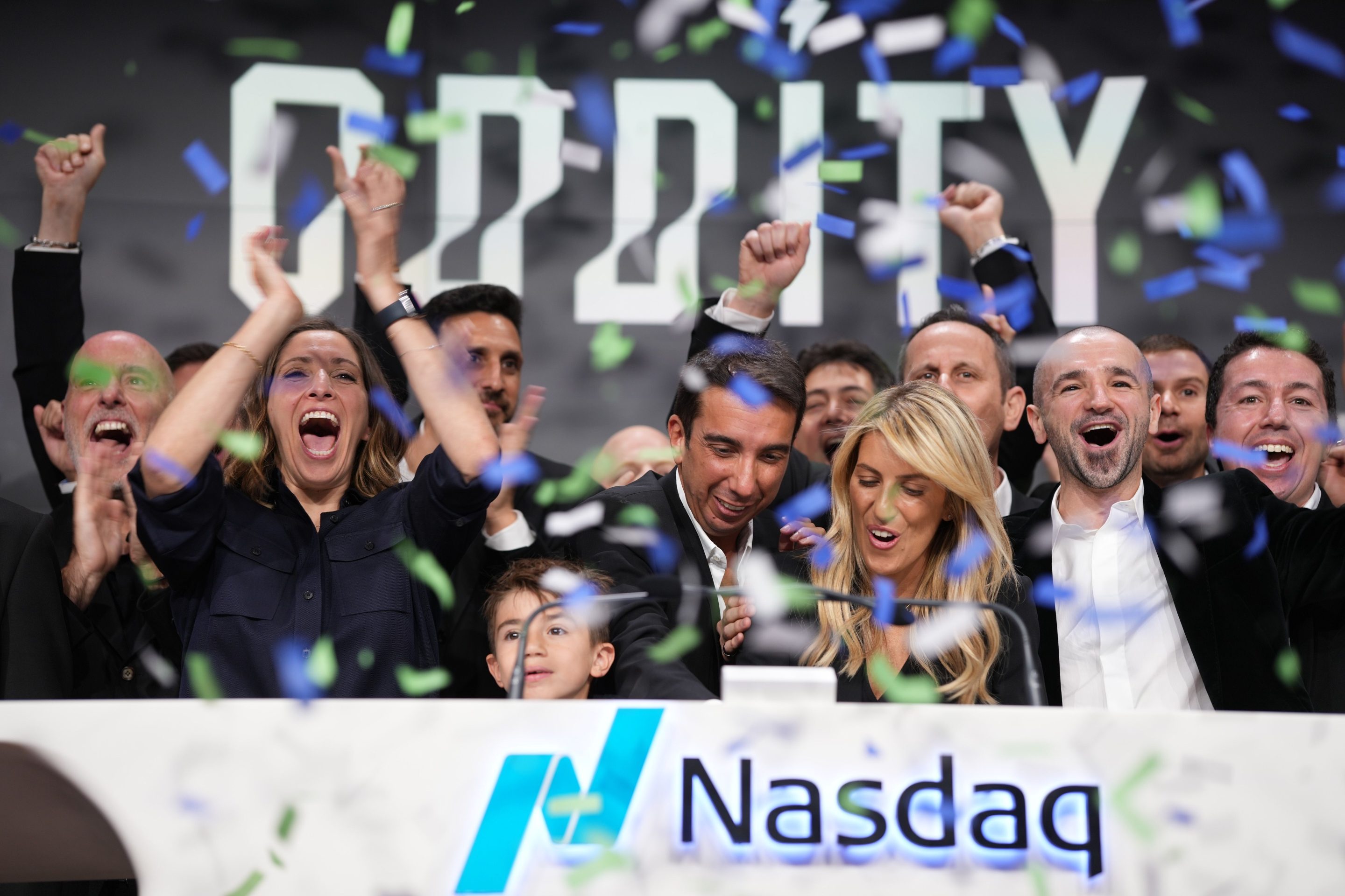 A group of people celebrate with confetti falling around them