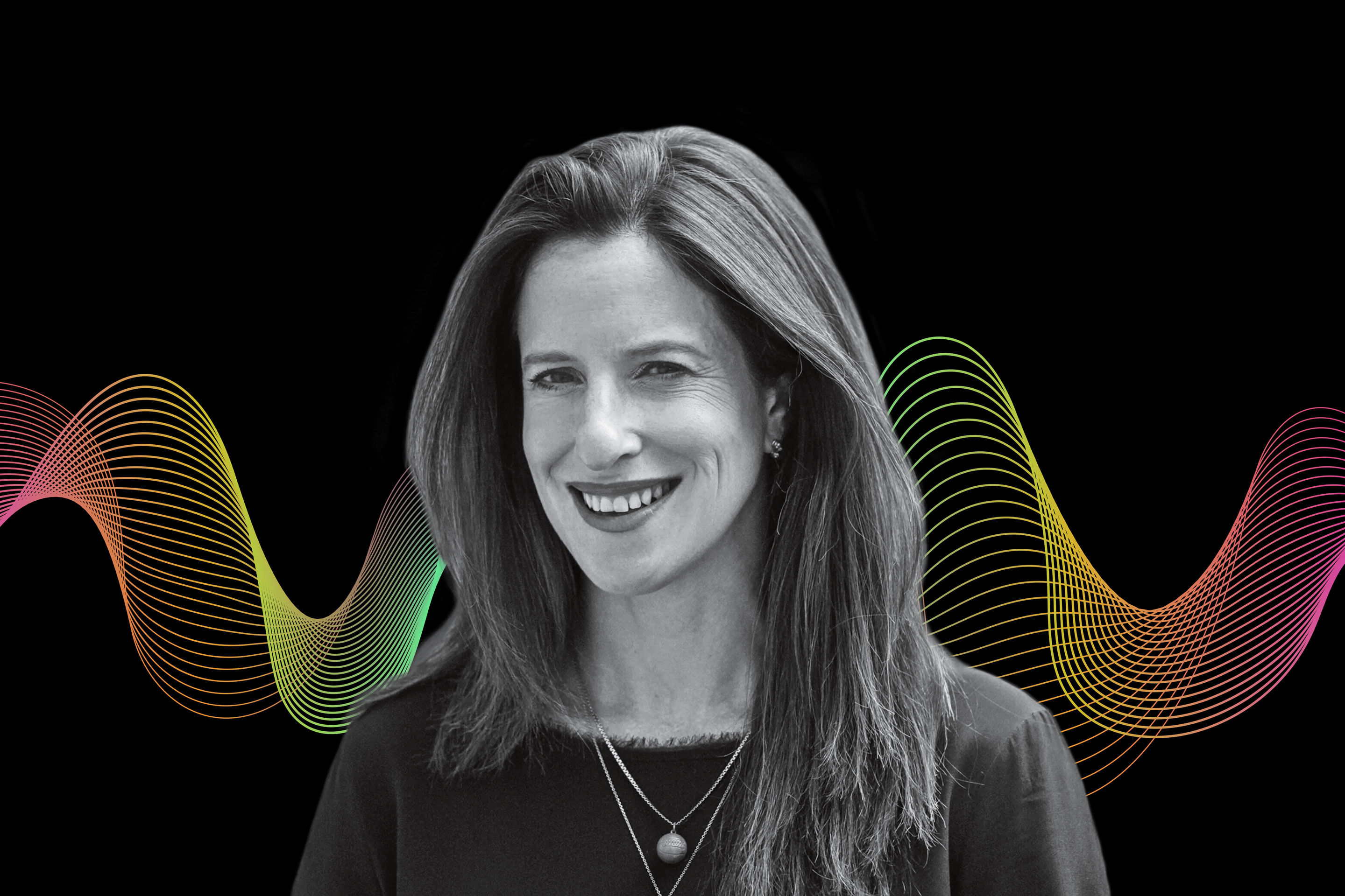 woman smiling in front of a black background