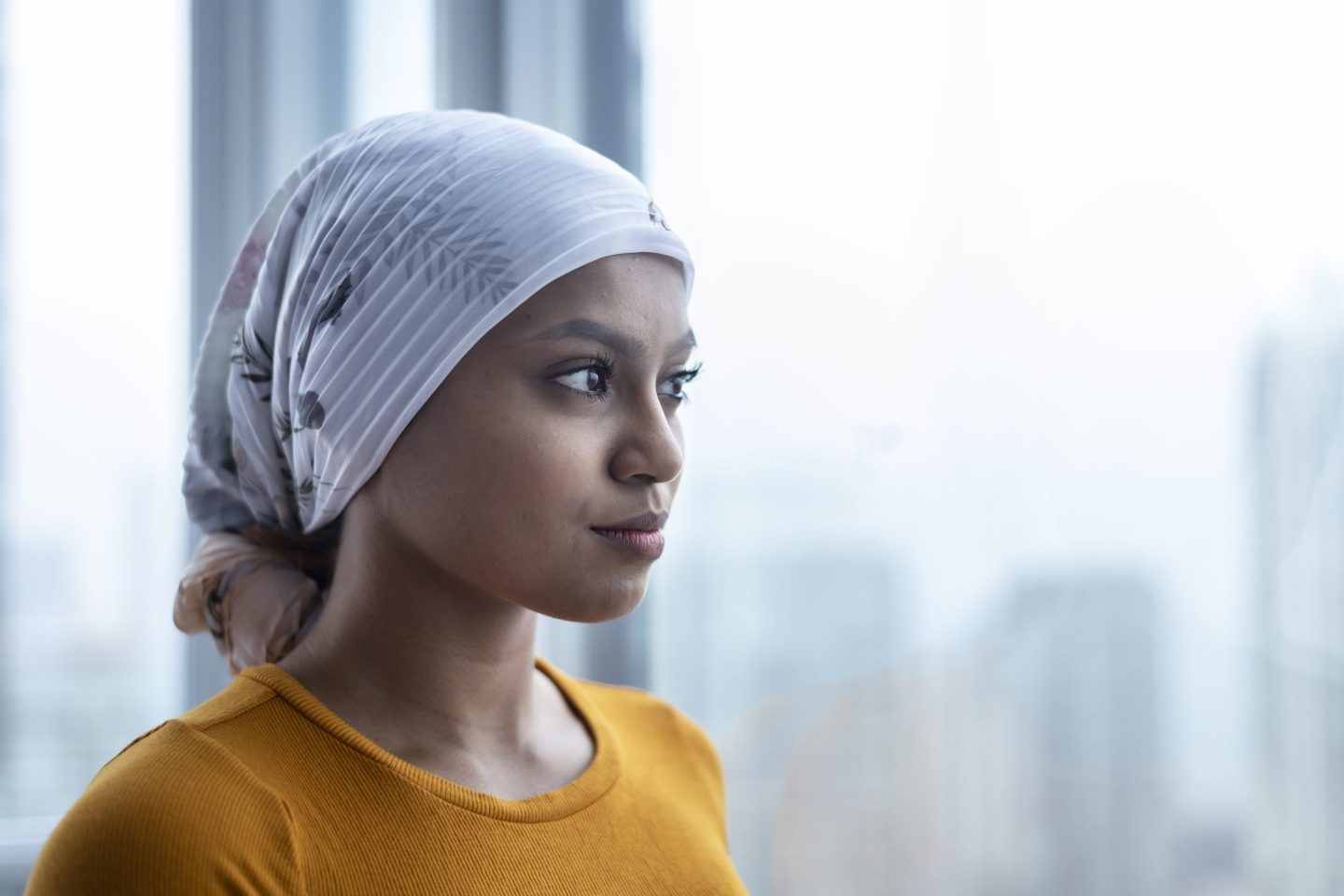 A woman with cancer wears a bandana.