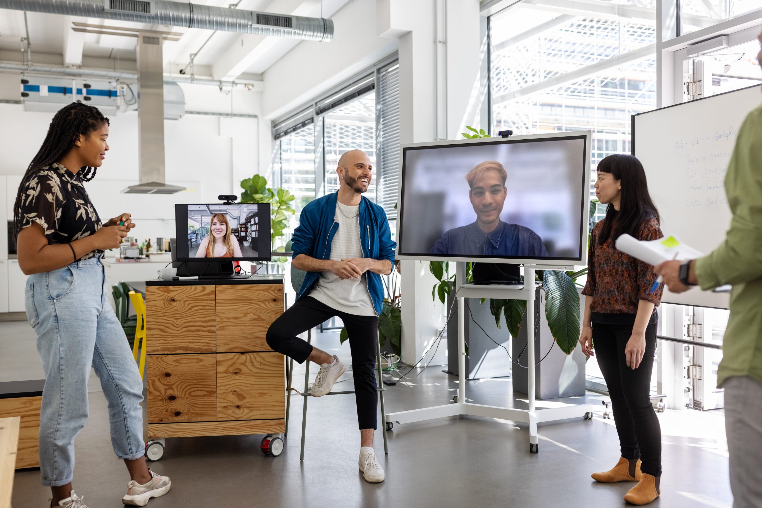Businesspeople having video call meeting with colleagues working remotely.