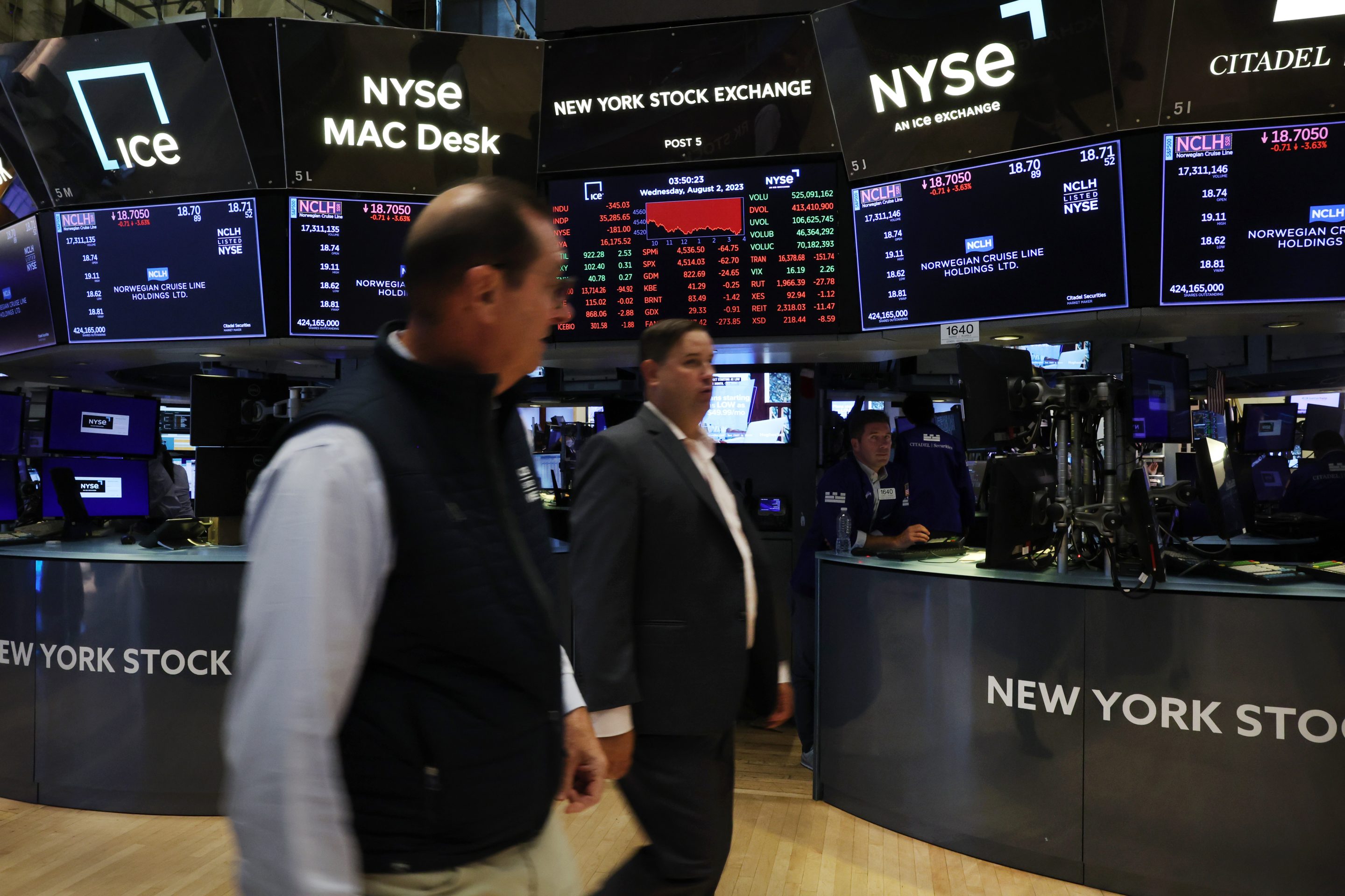 Traders work on the floor of the New York Stock Exchange on Aug. 2 following news Fitch Ratings downgraded the United States economy to AA+ from AAA.