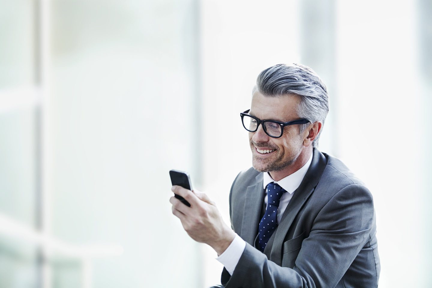 A businessman looking at his smartphone