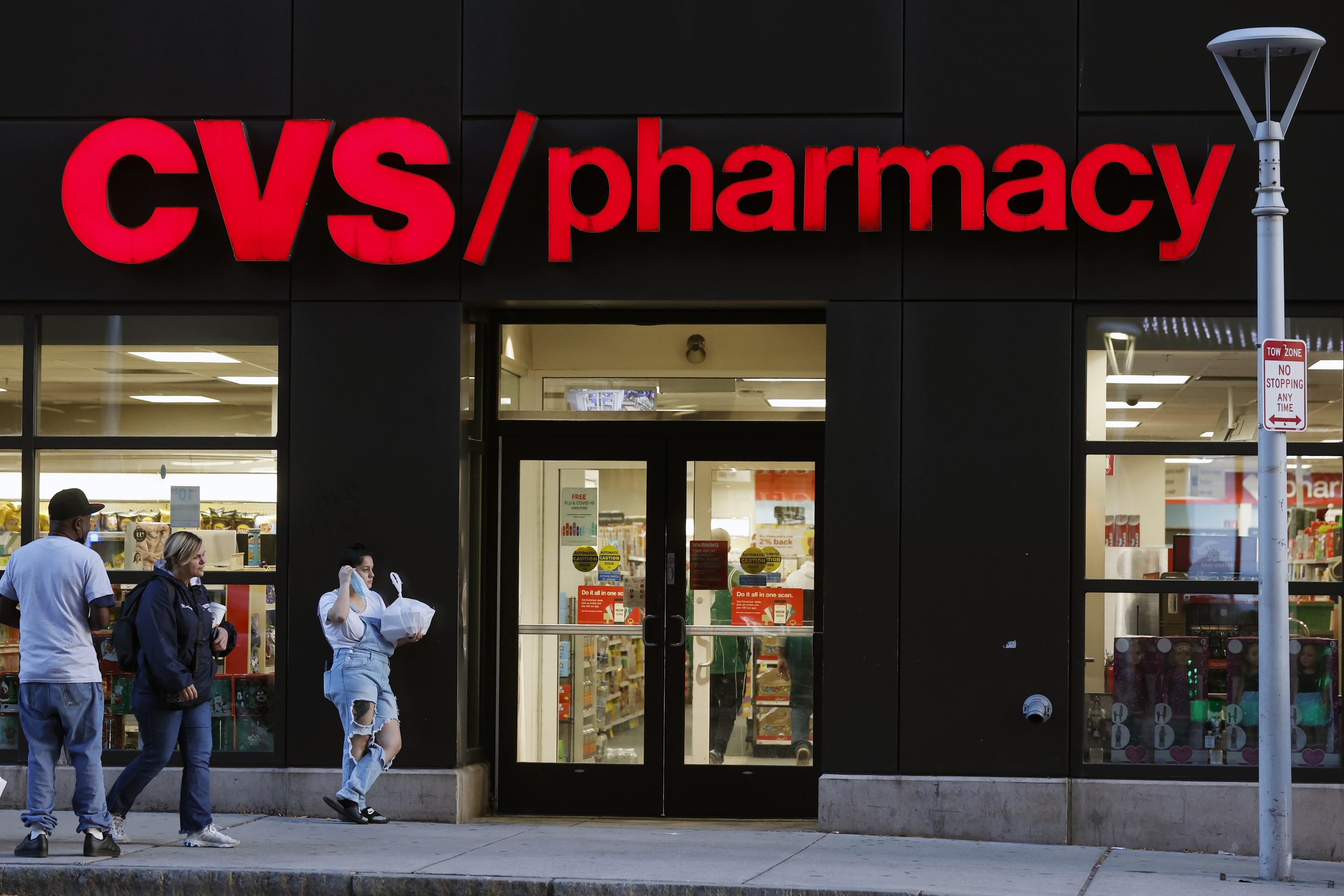 Customers walk to a CVS Pharmacy, on Nov 4, 2022, in Boston. 