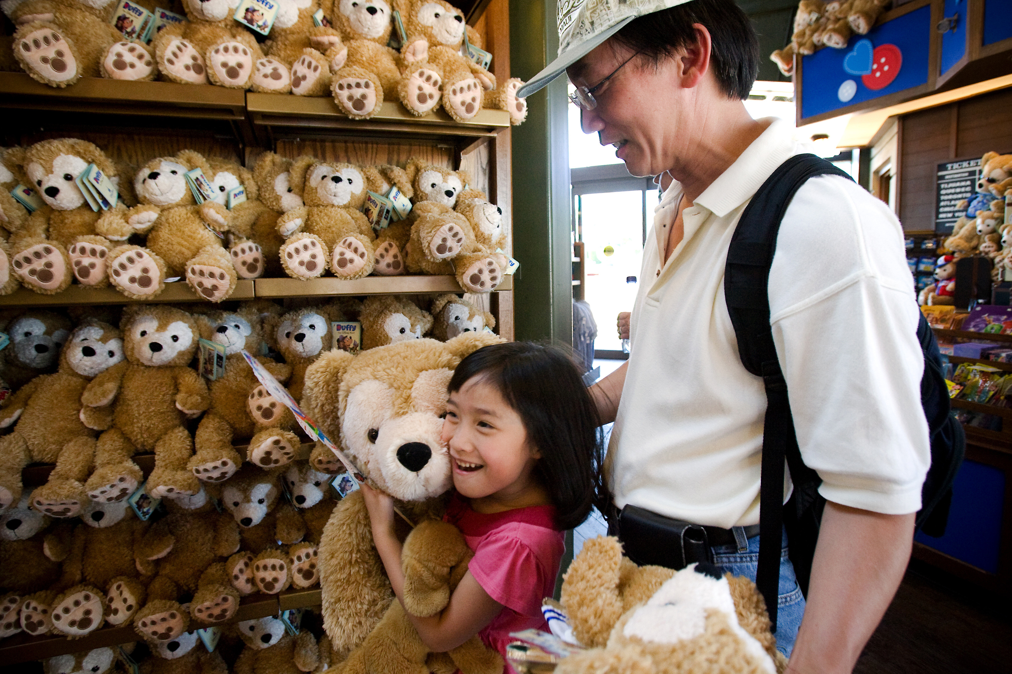 Girl holds Duffy the Disney Bear. 