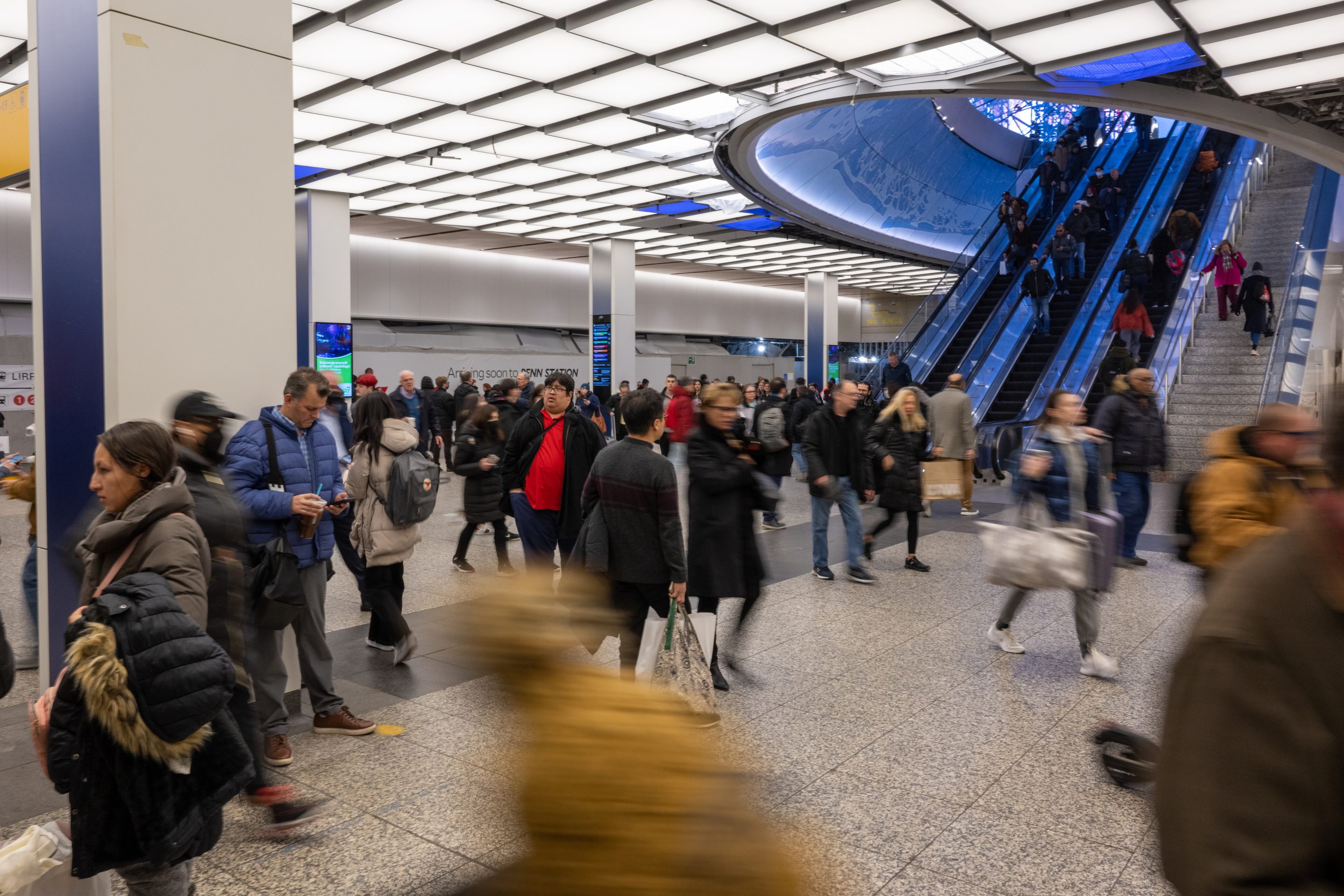 Crowds of people move through parts of the newly renovated Penn Station