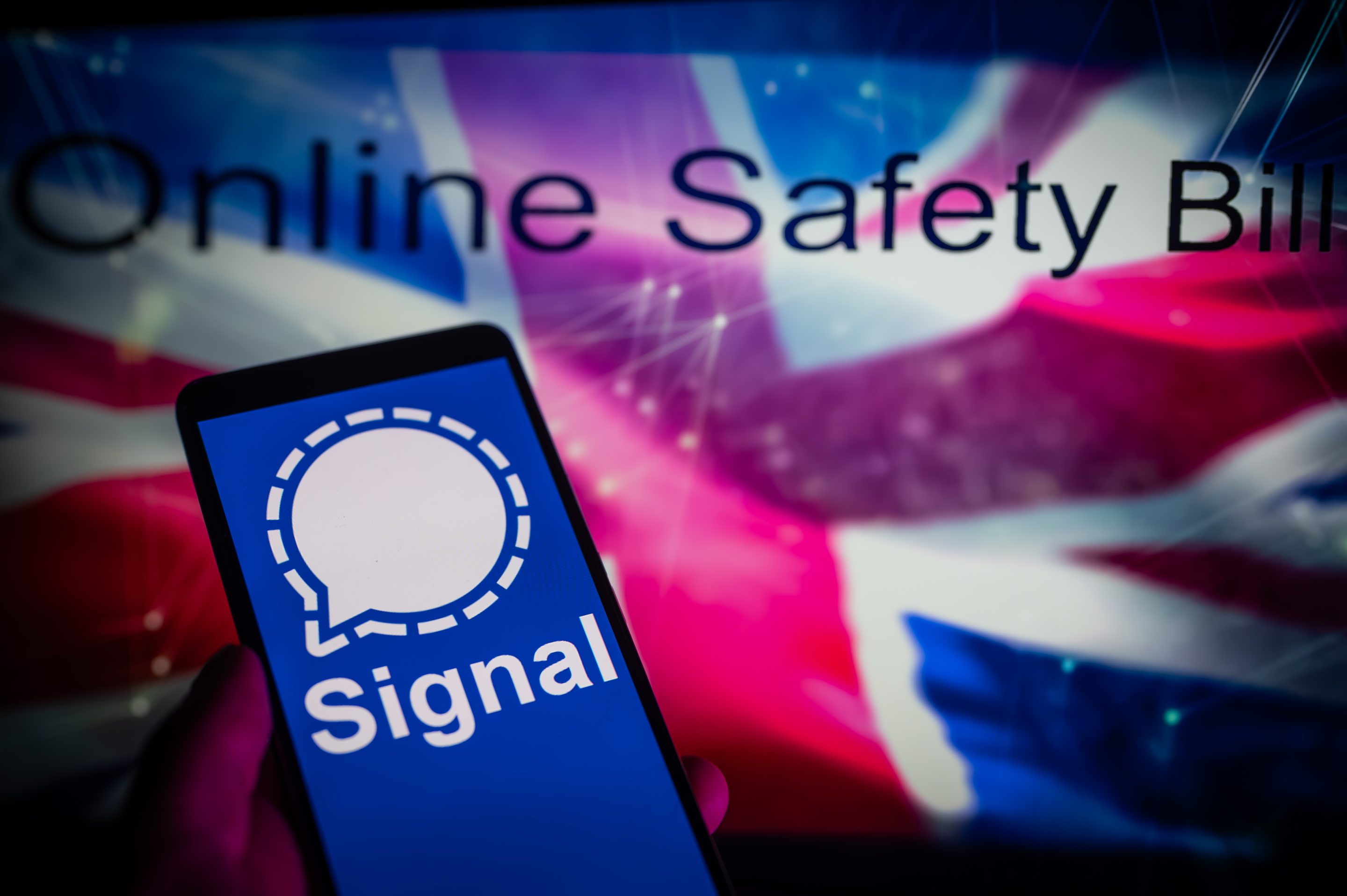 Signal app displayed on a mobile with in the background U.K flag with online safety bill seen on screen, in this photo illustration, on August 14, 2023 in Brussels, Belgium.