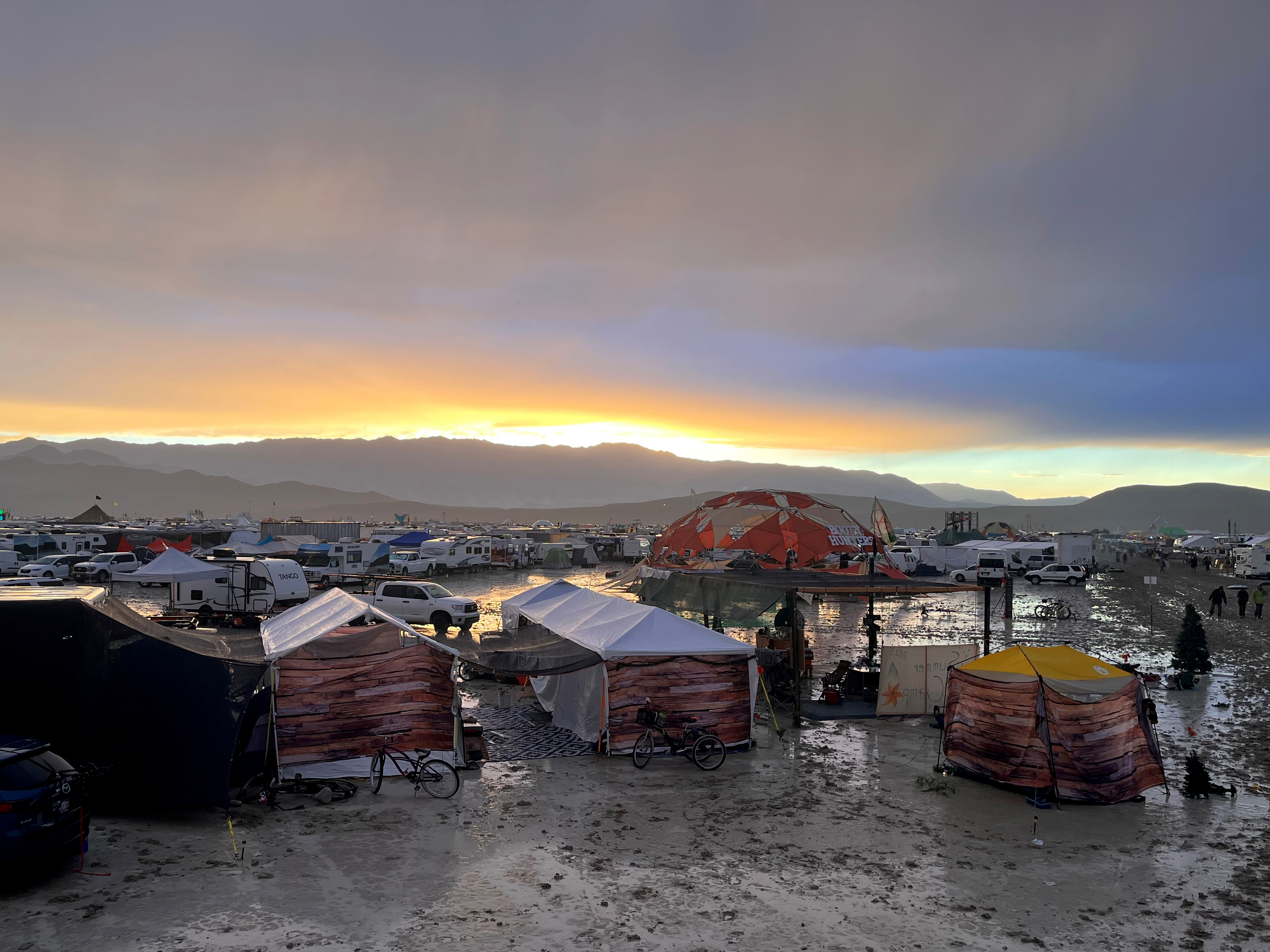 Tents between puddles and mud on the grounds of the Burning Man Festival 2023.