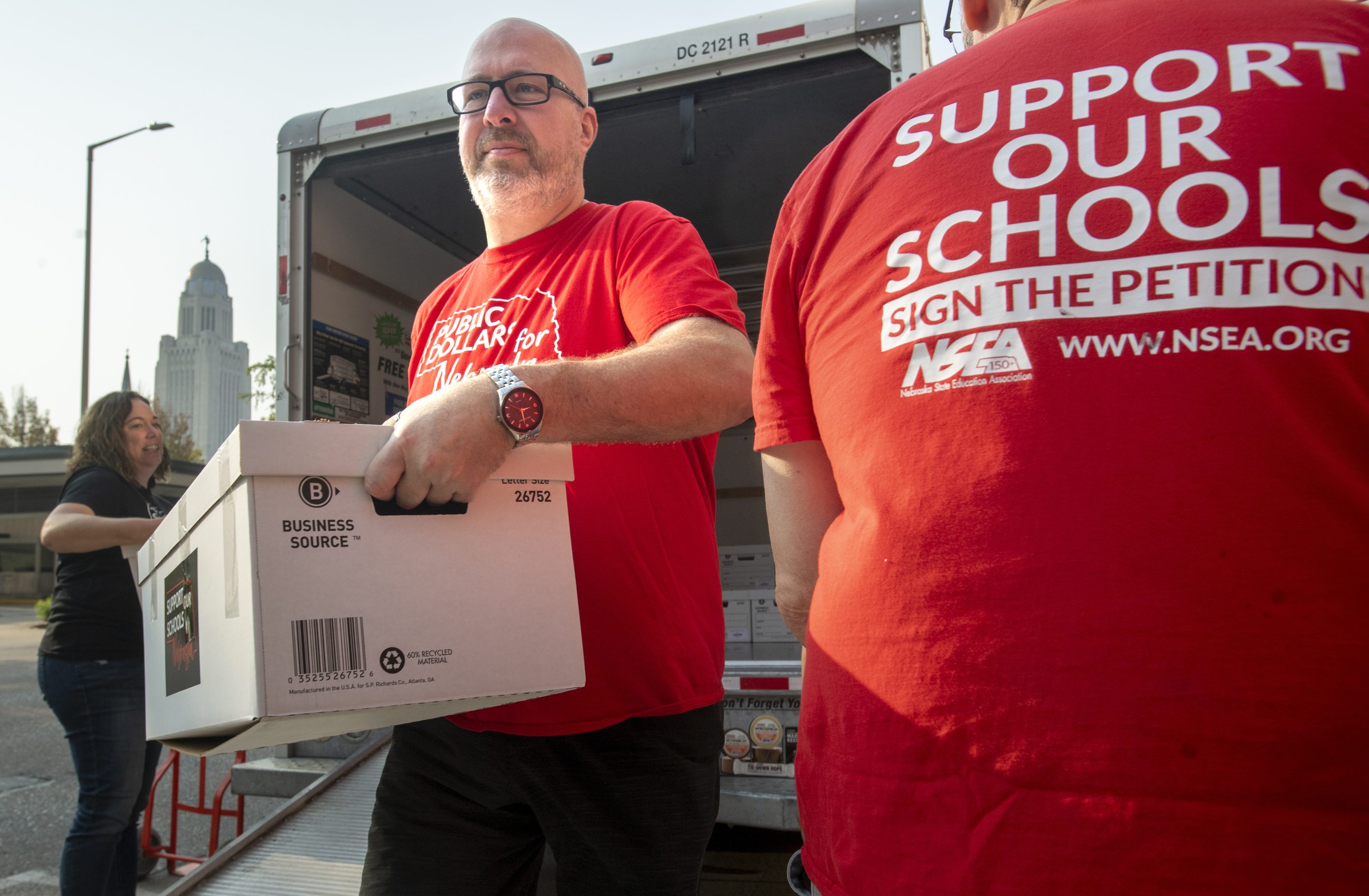 Paul Schulte, a sponsor of the Support Our Schools Nebraska petition drive, delivers a box of signatures to the Nebraska Secretary of State, on Aug. 30, 2023, in Lincoln, Neb.