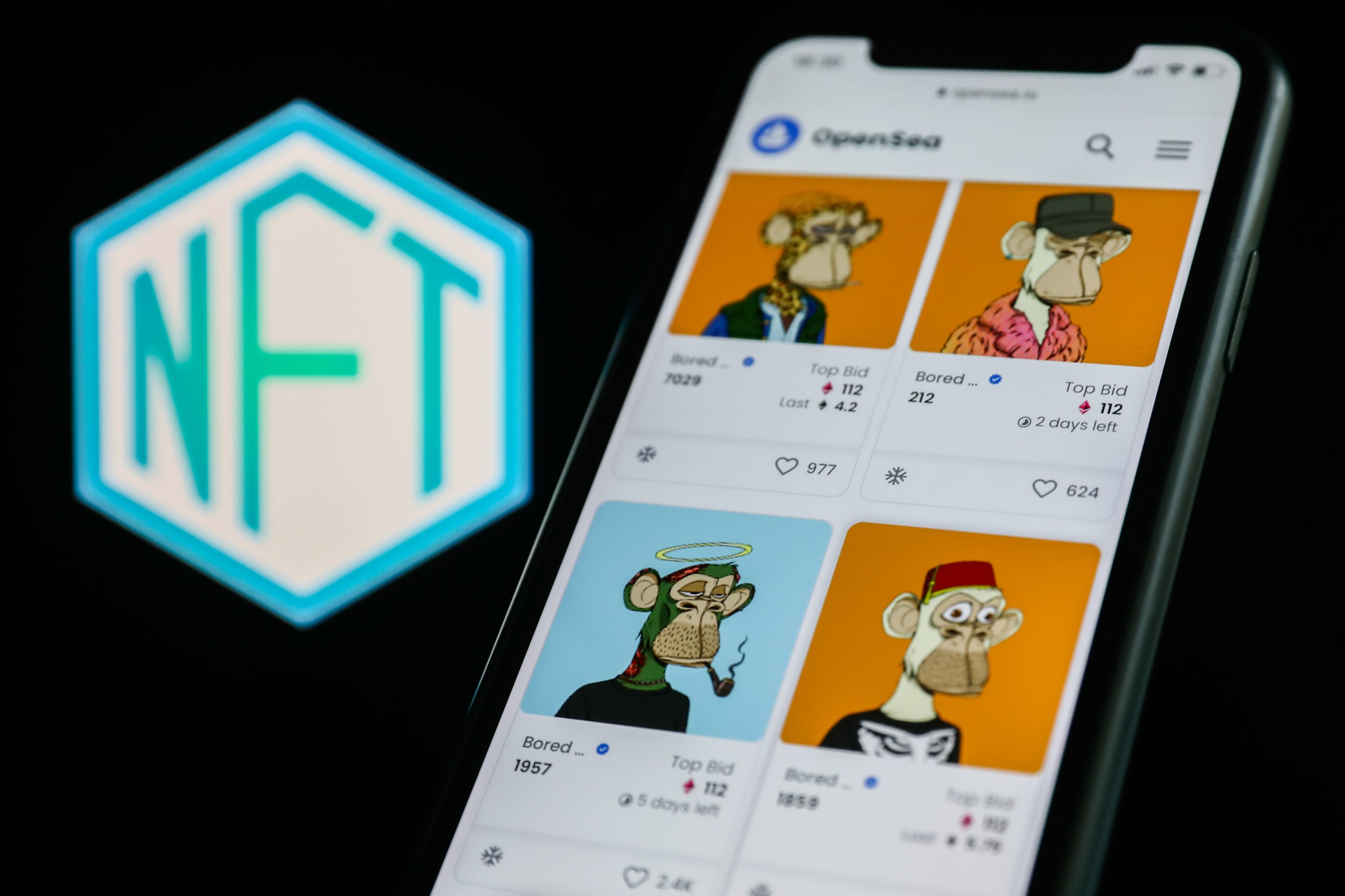 iphone displaying colorful NFTs depicting cartoon apes
