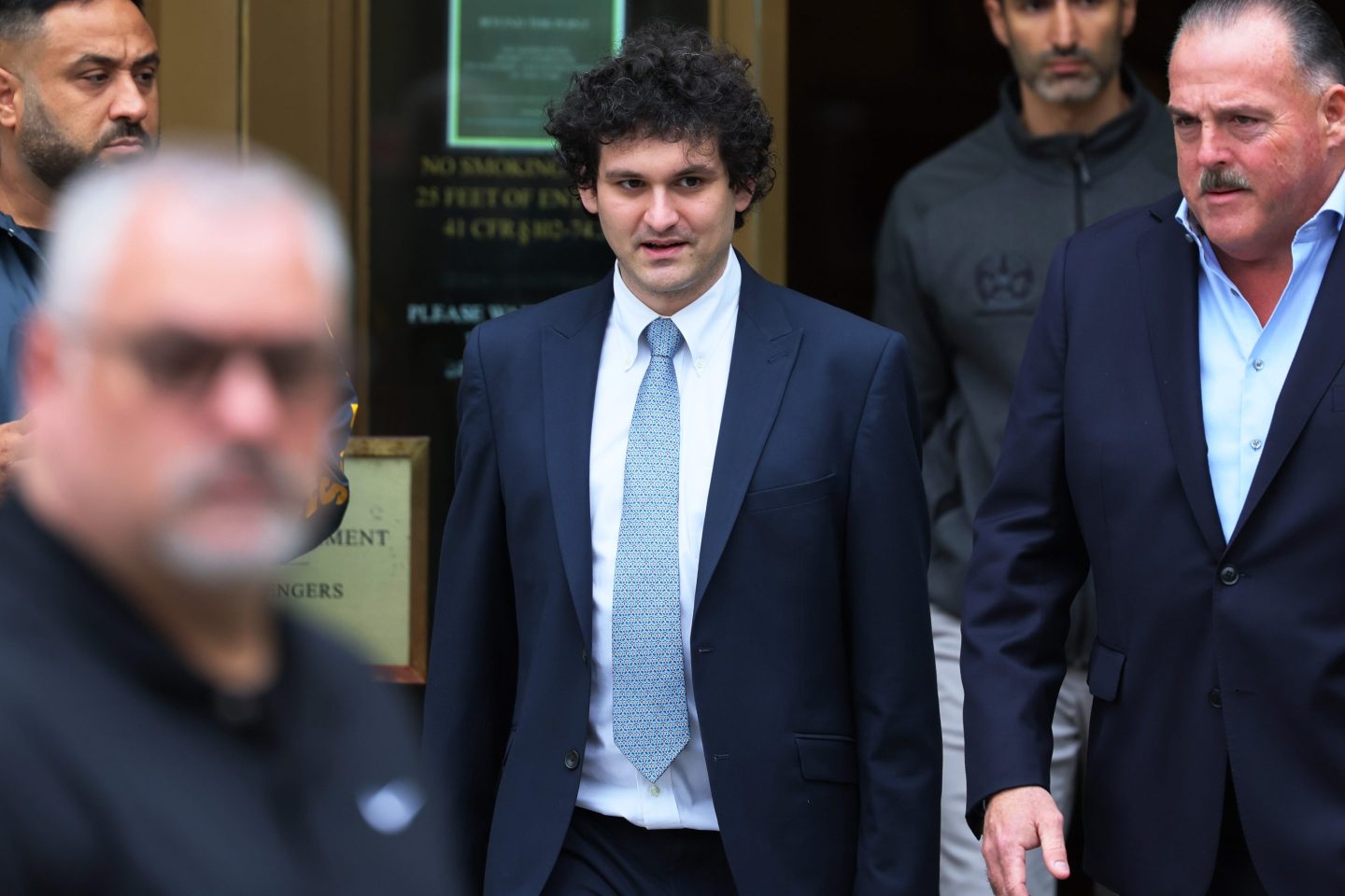man in suit and tie leaving courthouse