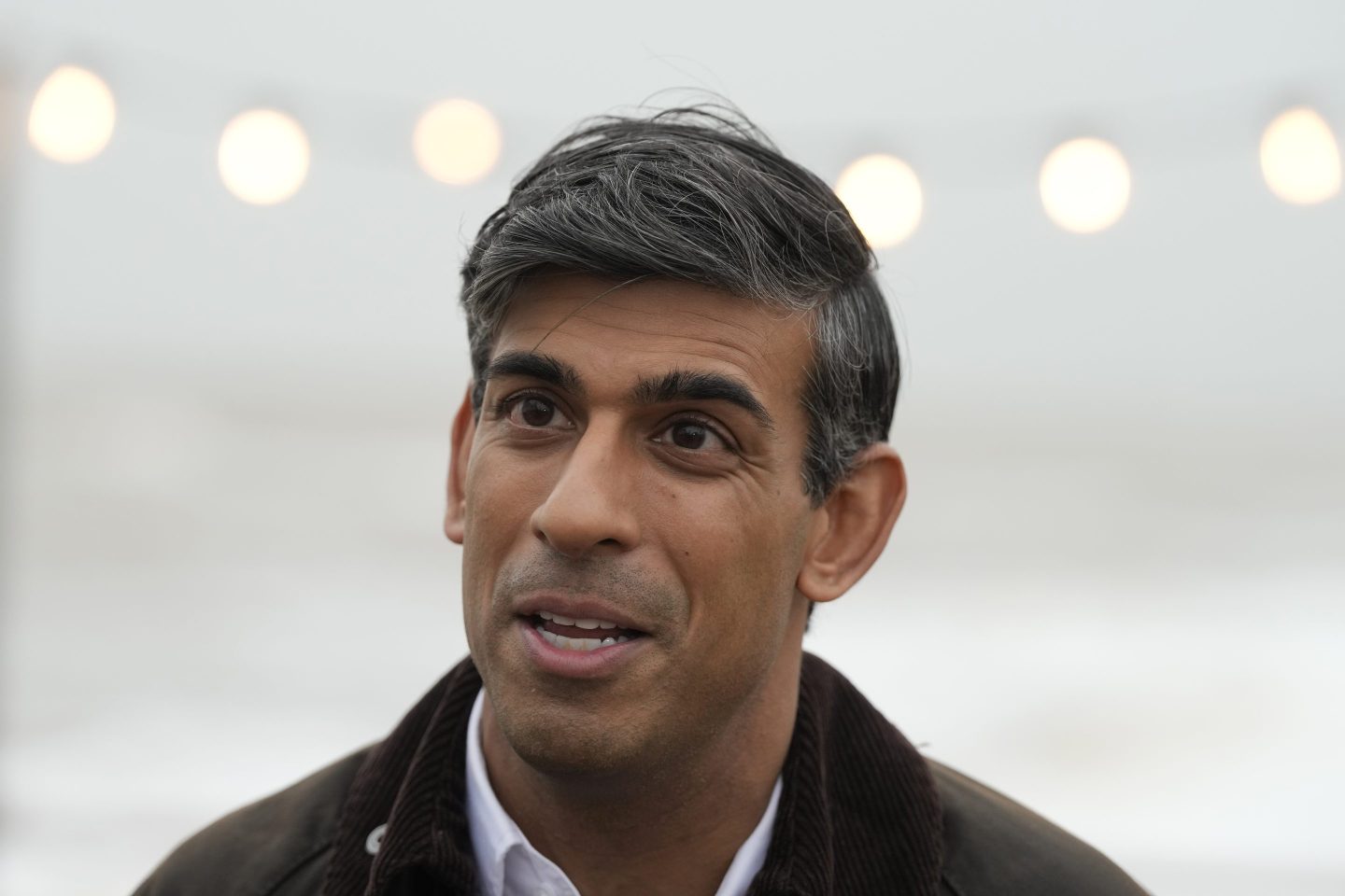 British Prime Minister Rishi Sunak speaks to a TV reporter