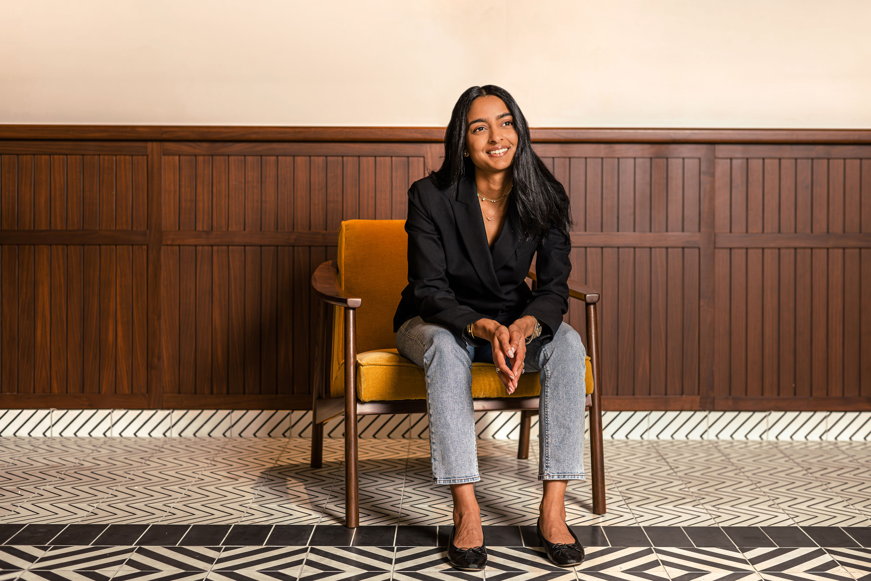 businesswoman sitting in a chair, posed for a portrait