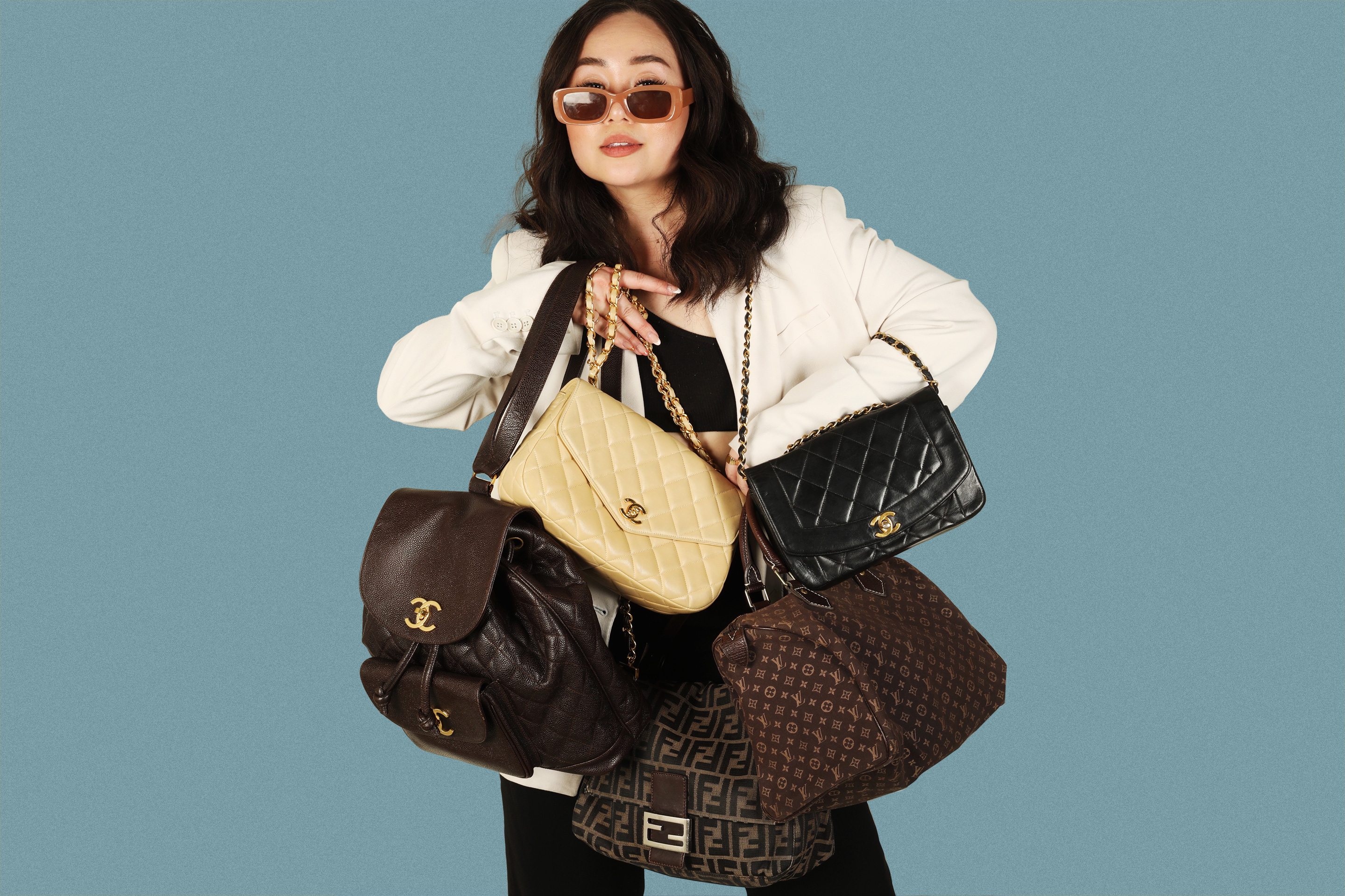 Nica Yusay holding a few of her favorite handbags.