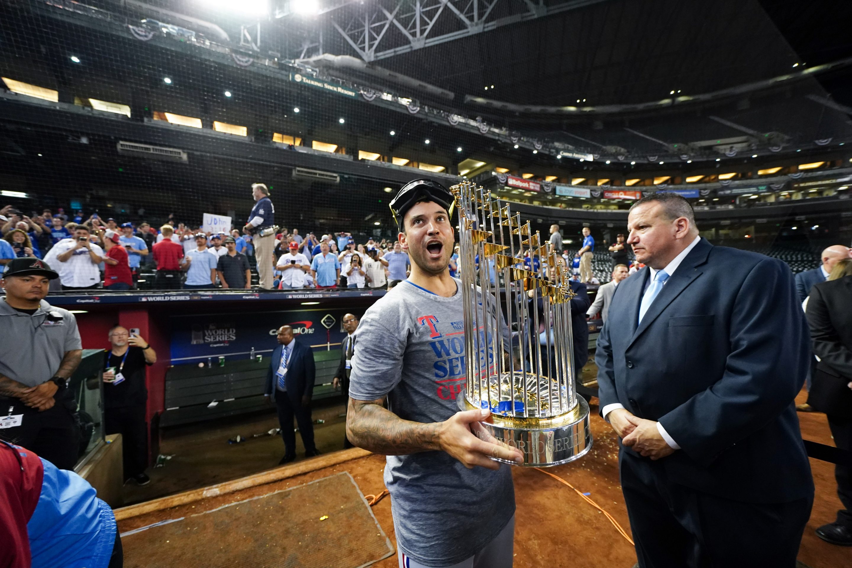 Matt Bush of the Texas Rangers holds the Commissioner's Trophy after winning Game 5 of the 2023 World Series.