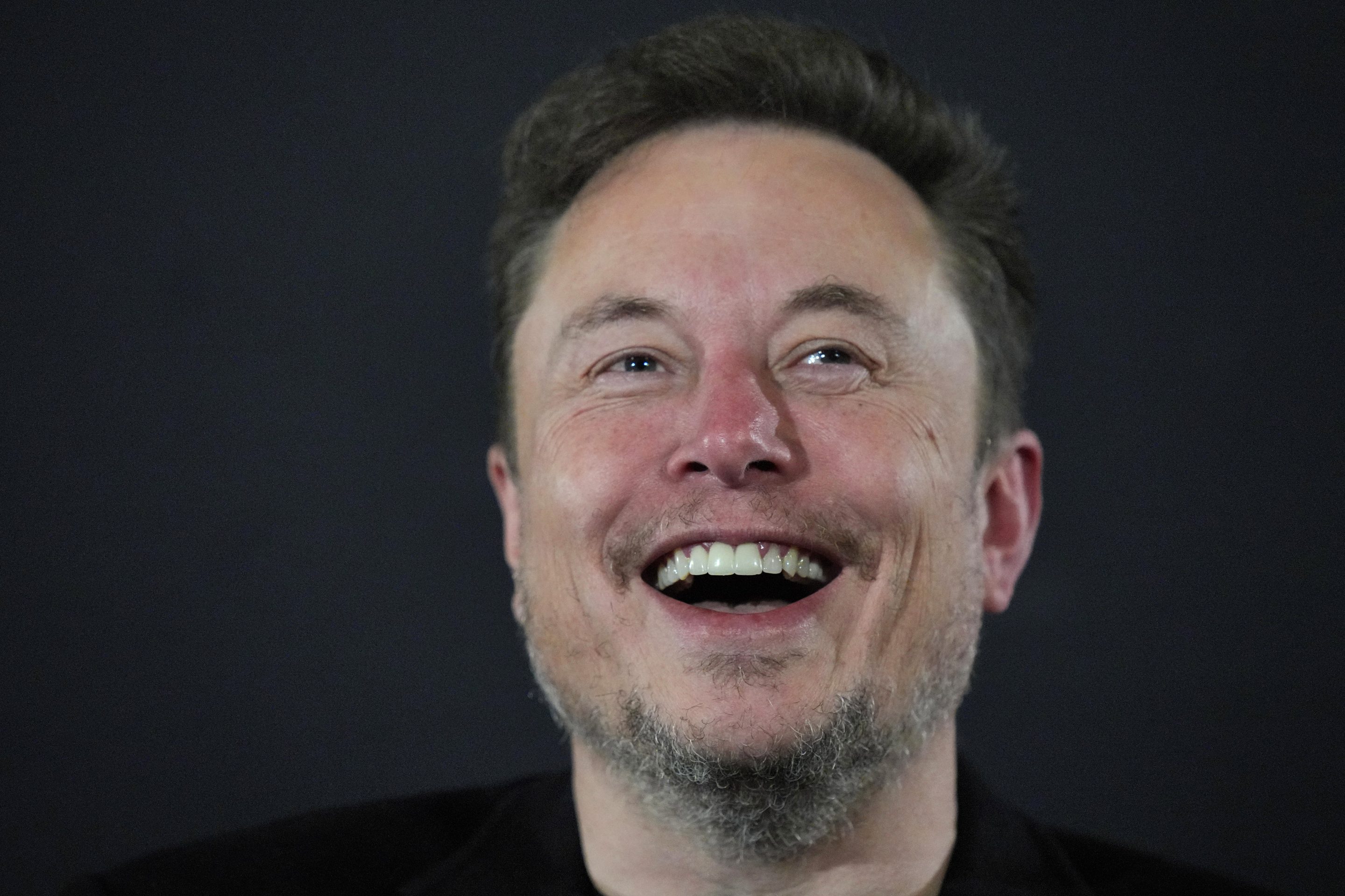 Tesla and SpaceX's CEO Elon Musk laughs during an in-conversation event with British Prime Minister Rishi Sunak (not pictured) at Lancaster House on November 2, 2023 in London, England. Sunak discussed AI with Elon Musk in a conversation that is played on the social network X, which Musk owns.