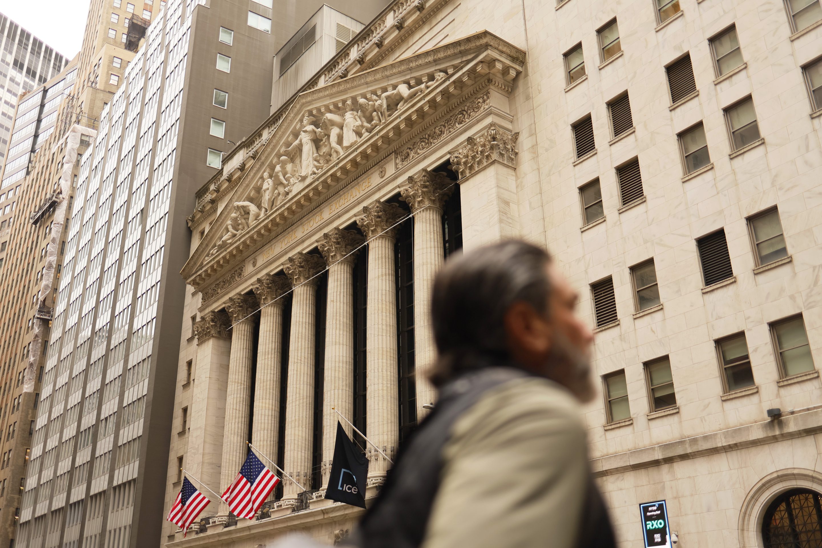 People walk past the New York Stock Exchange.