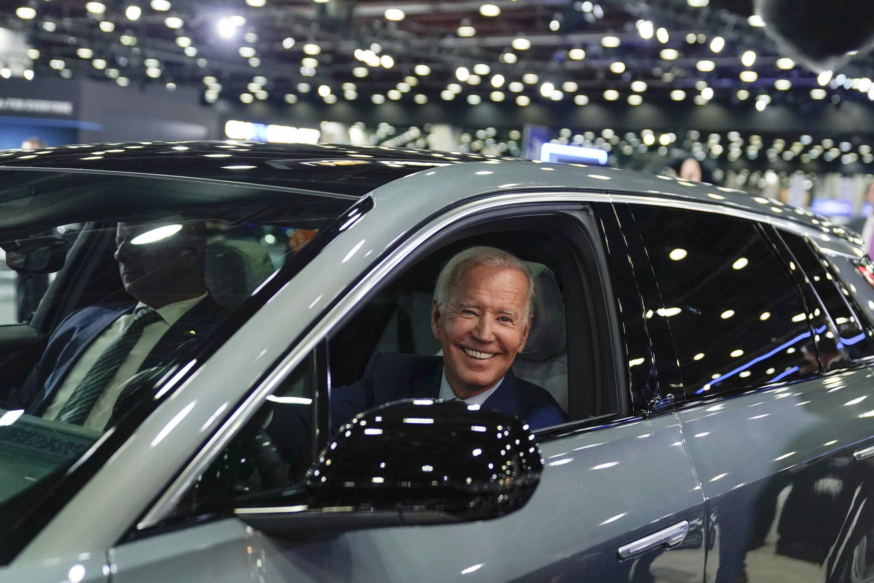 Biden drives a Cadillac Lyriq through the Detroit Auto Show.