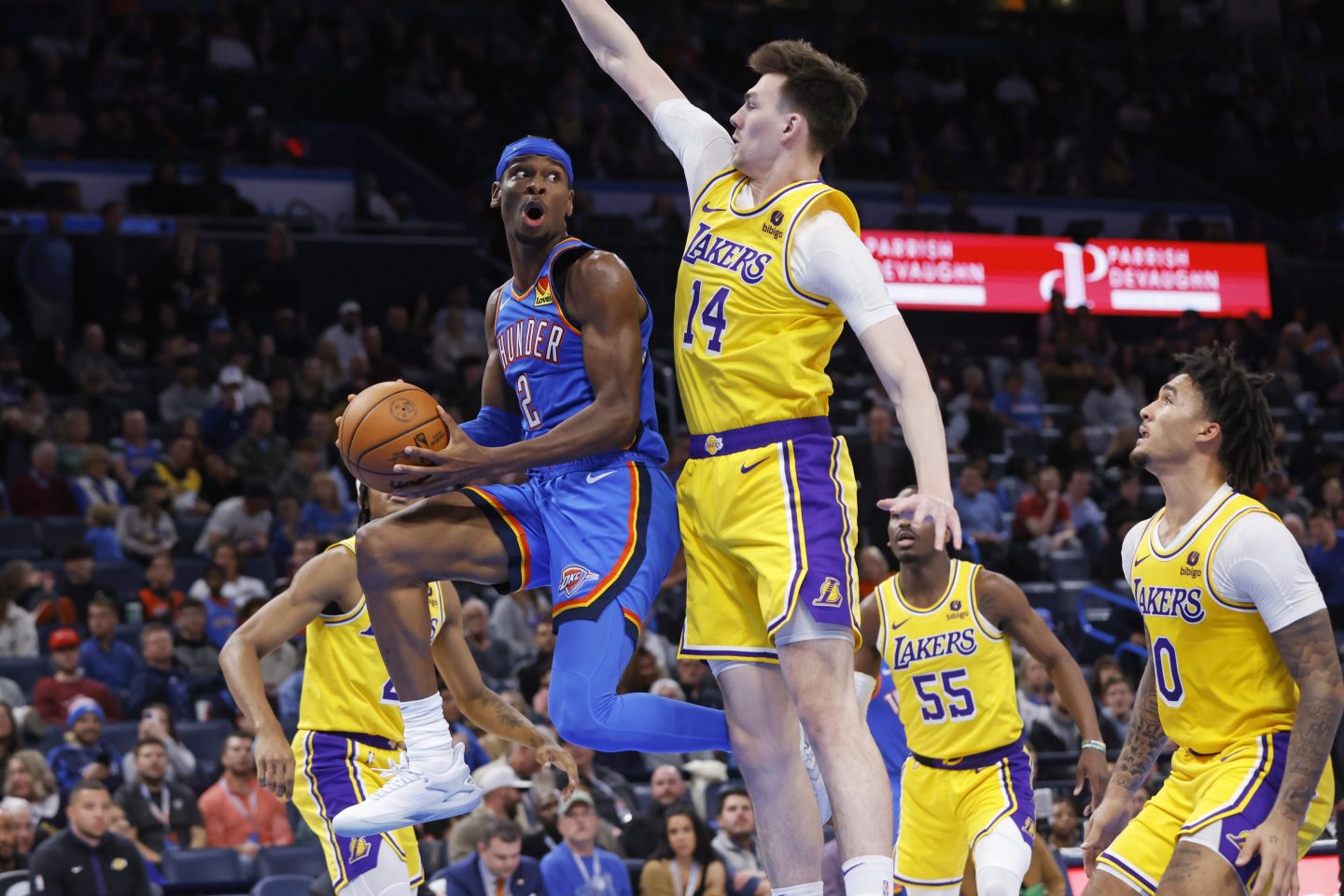 Oklahoma City Thunder guard Shai Gilgeous-Alexander (2) prepares to pass the ball away from Los Angeles Lakers center Colin Castleton (14) during the second half of an NBA basketball game Nov. 30, 2023, in Oklahoma City.