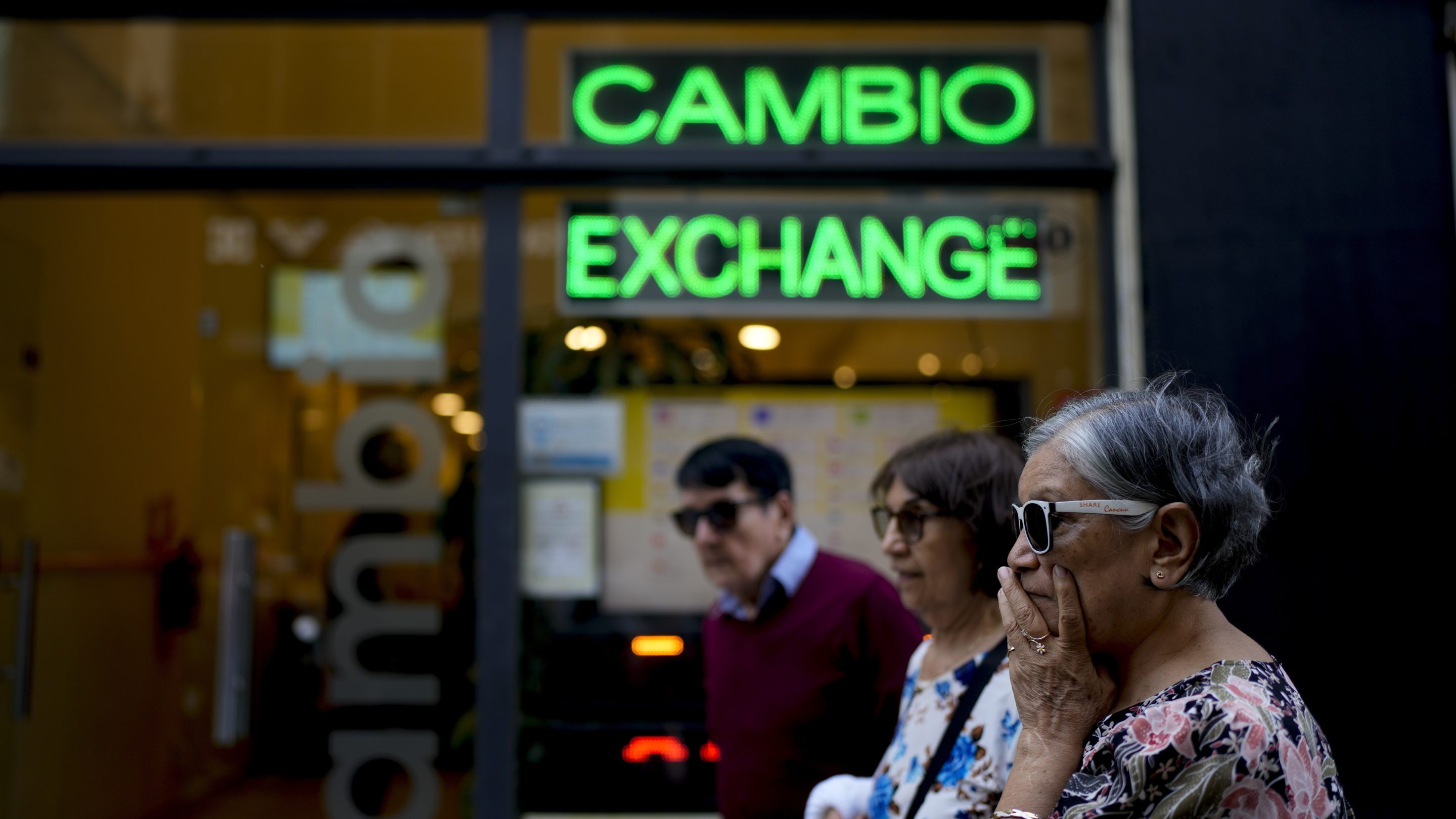 Pedestrians walk past a money exchange shop in Buenos Aires, on Oct. 10, 2023.