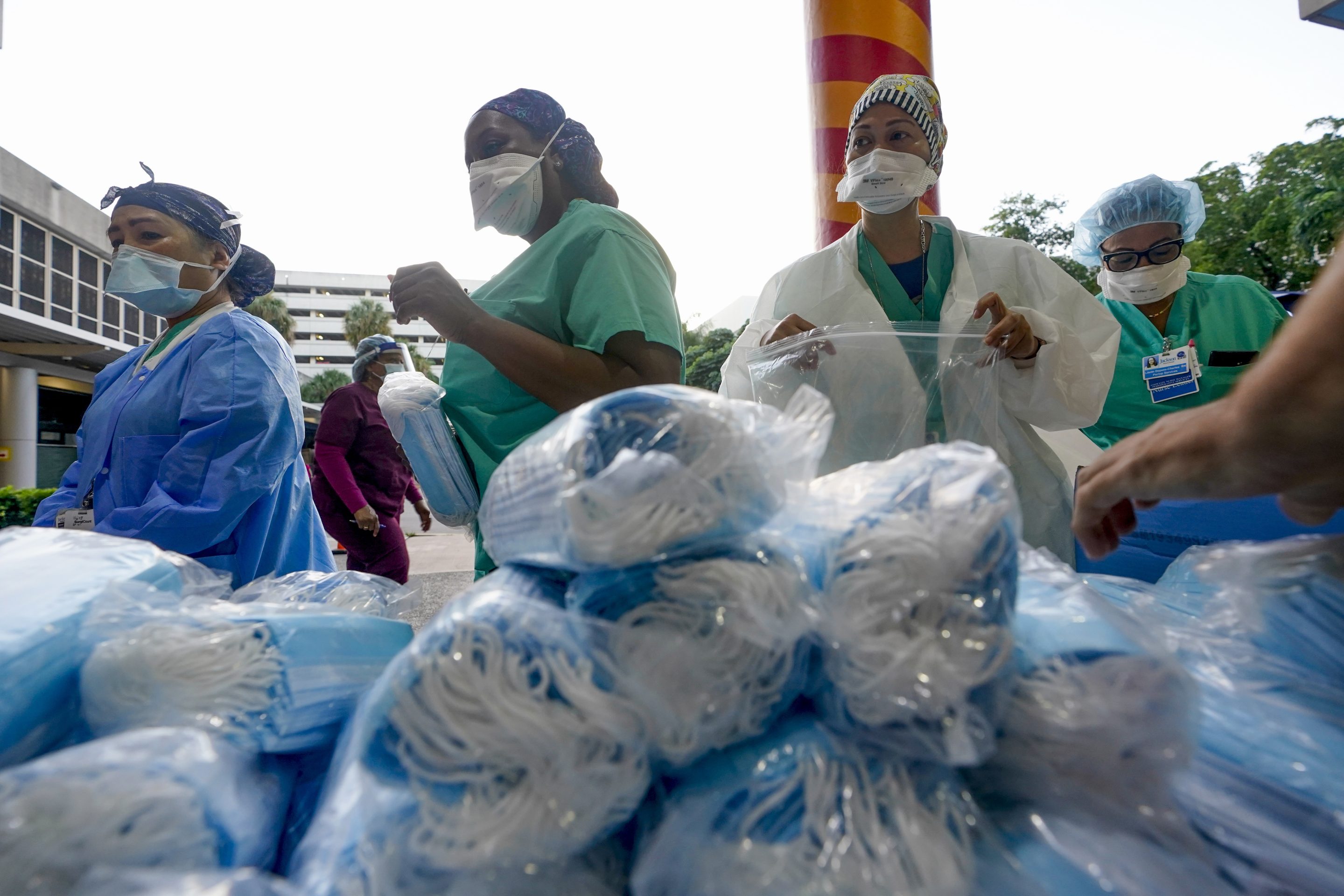 Healthcare workers line up for free personal protective equipment at Jackson Memorial Hospital, on Sept. 22, 2020, in Miami. 