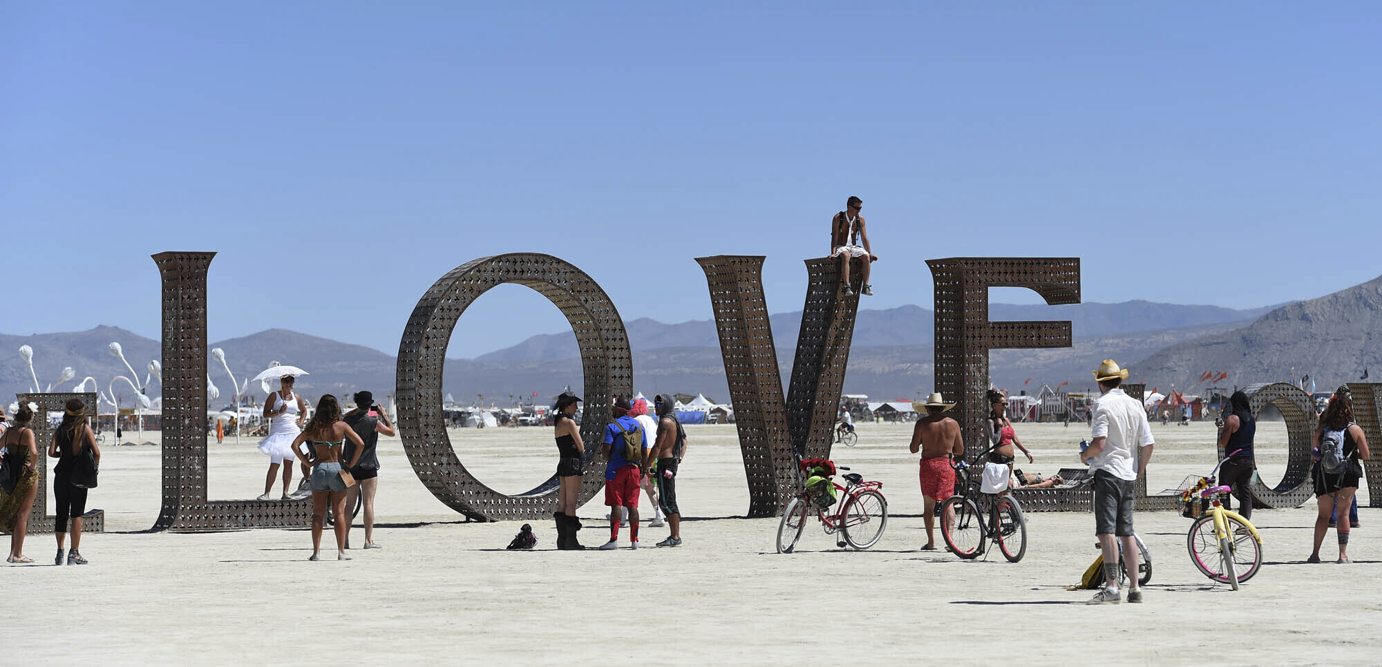 Participants walk around at the Burning Man festival on the Black Rock Desert of Gerlach, Nev., on Aug. 27, 2014. 