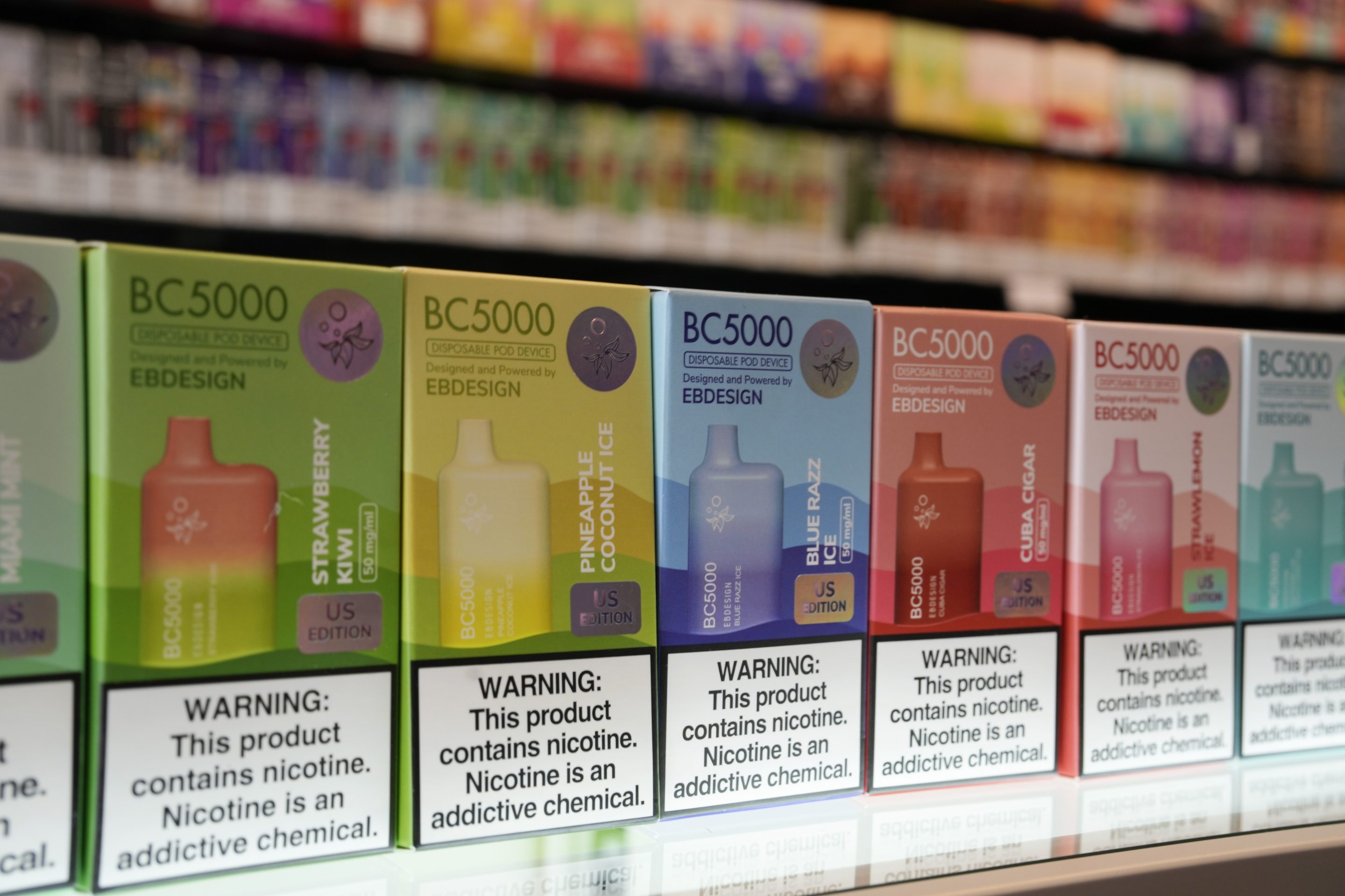 Varieties of disposable flavored electronic cigarette devices manufactured by EB Design, formerly known as Elf Bar, are displayed at a store in Pinecrest, Fla., in June.