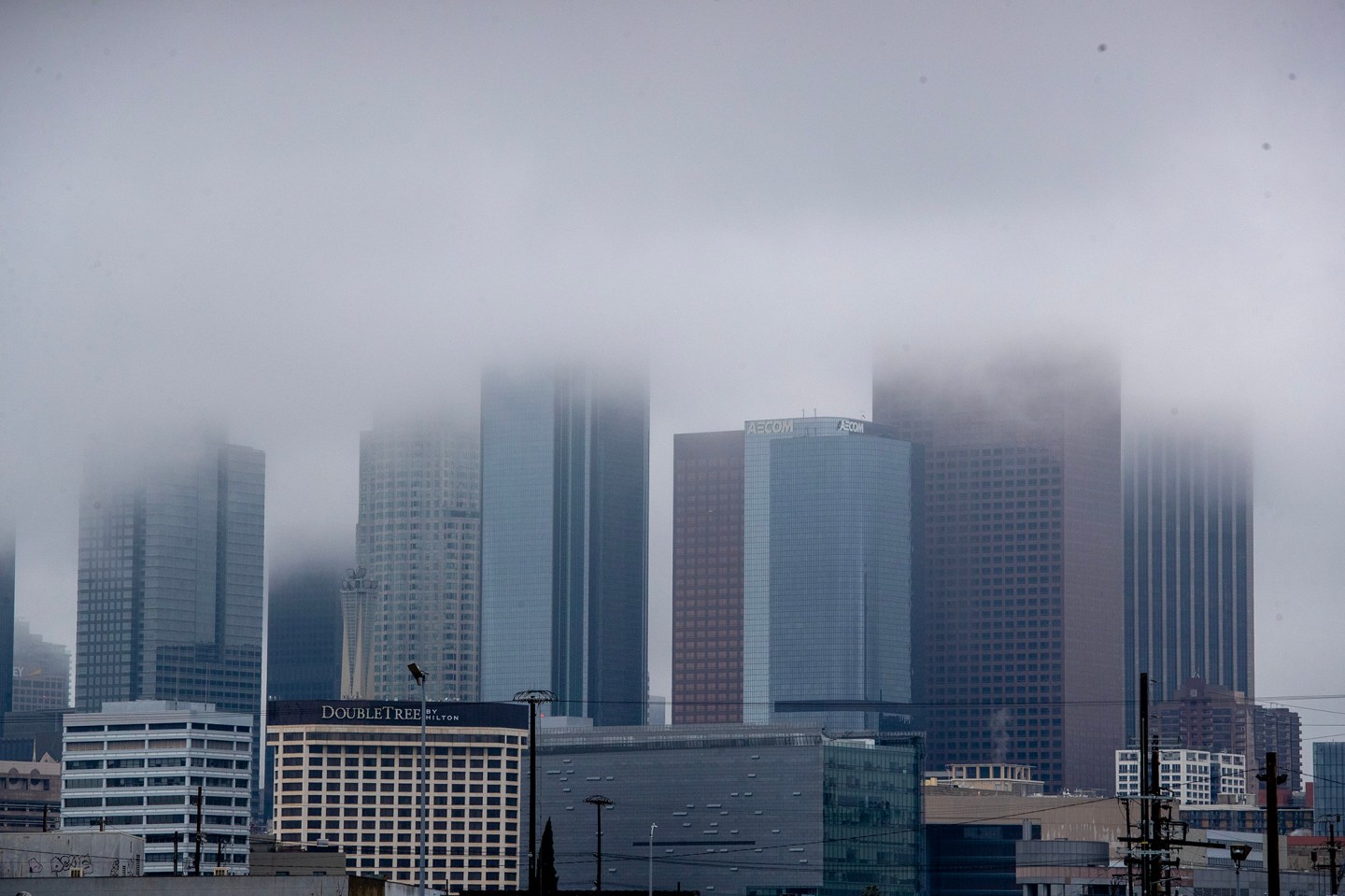 Low clouds obscure the tops of downtown skyscrapers in Los Angeles