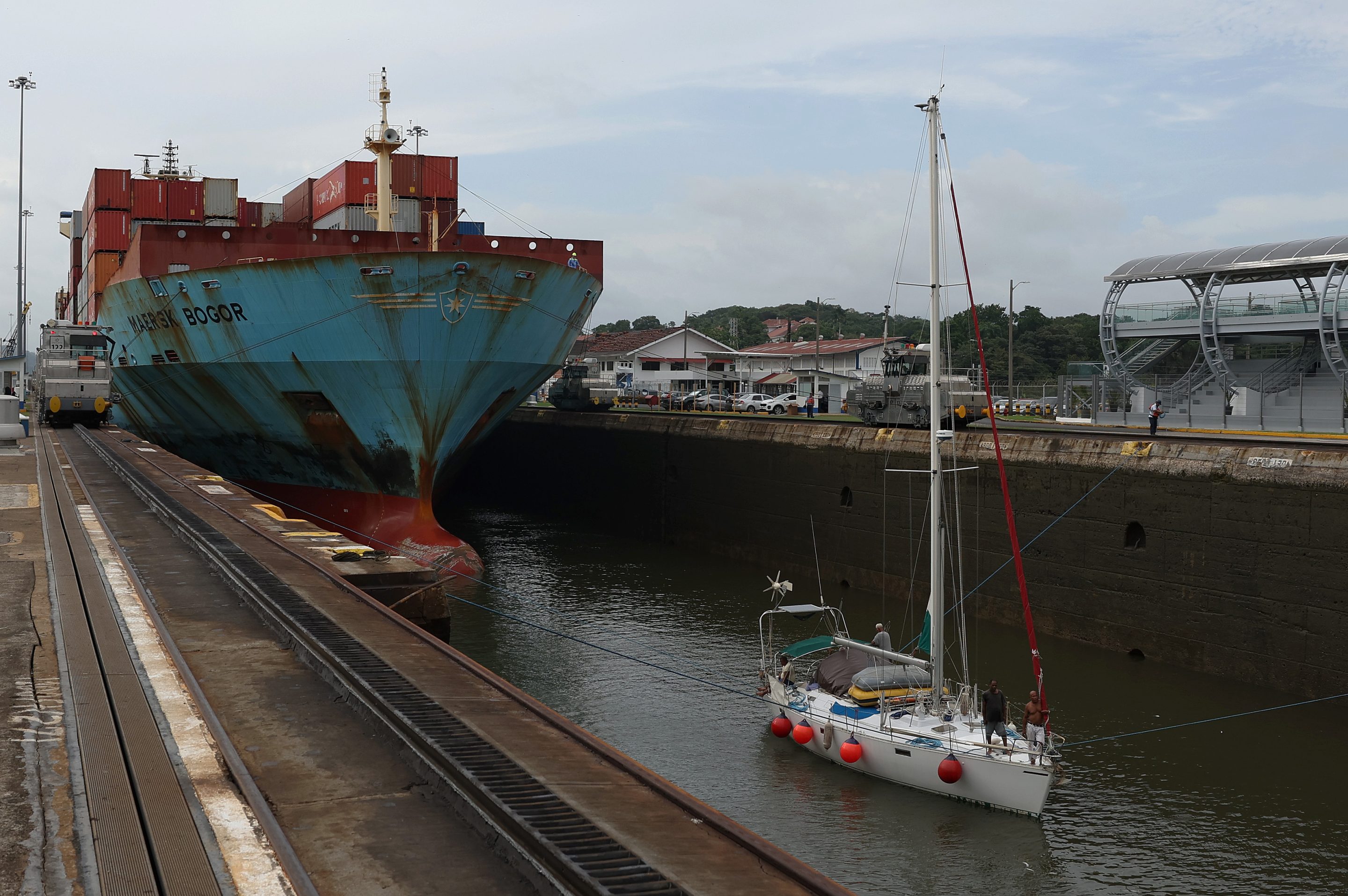 The container ship Maersk Bogor passes through the Miraflores locks with a small boat while transiting the Panama Canal on Sept. 22, 2023 in Panama City, Panama. 