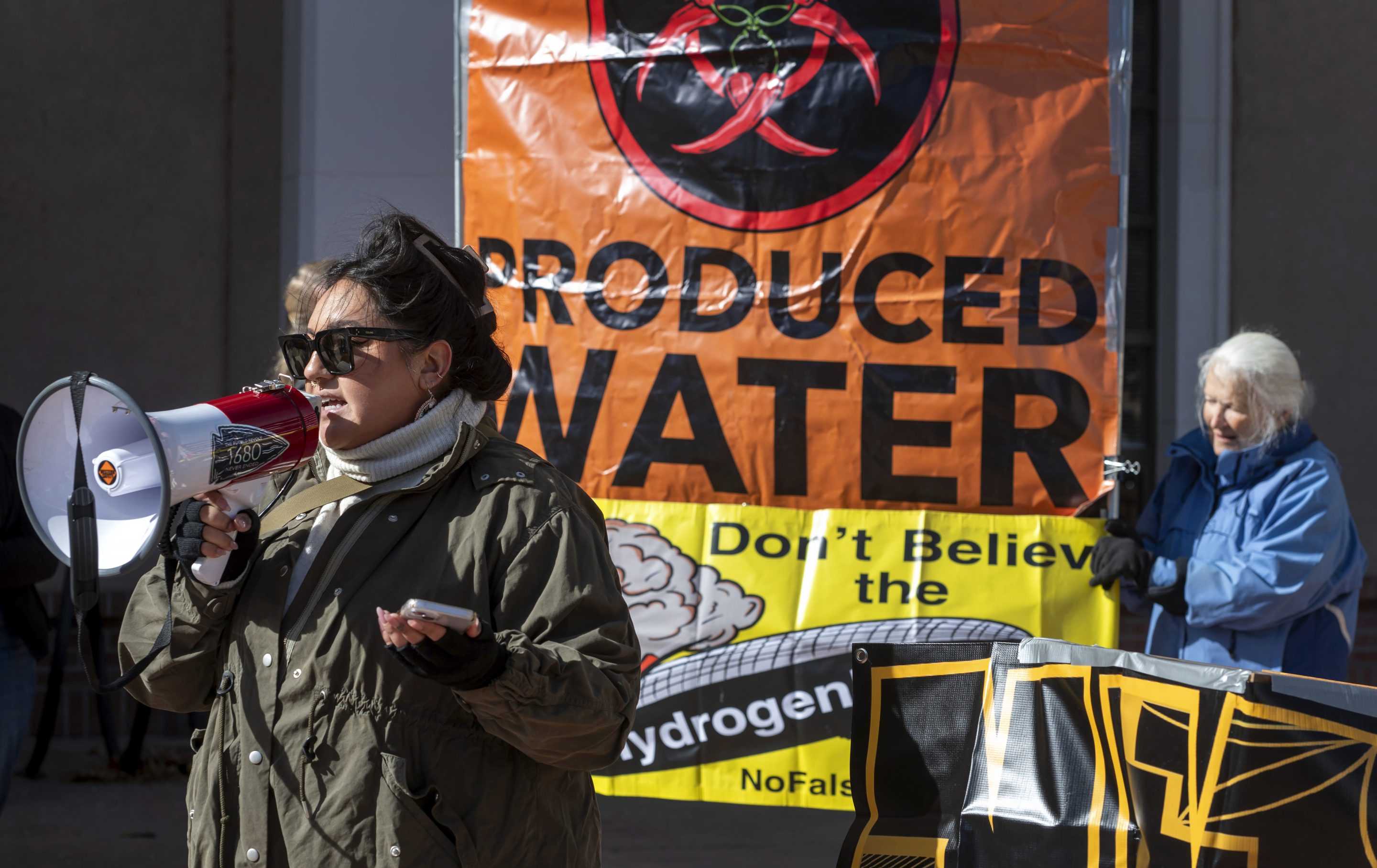 Julia Bernal, with Pueblo Action Alliance, speaks at a protest against an initiative by Gov. Michelle Lujan Grisham to develop a strategic new source of water, buying treated water that is the byproduct of oil and natural gas drilling, then treating it and selling it back to industry, on Jan. 22, 2024.