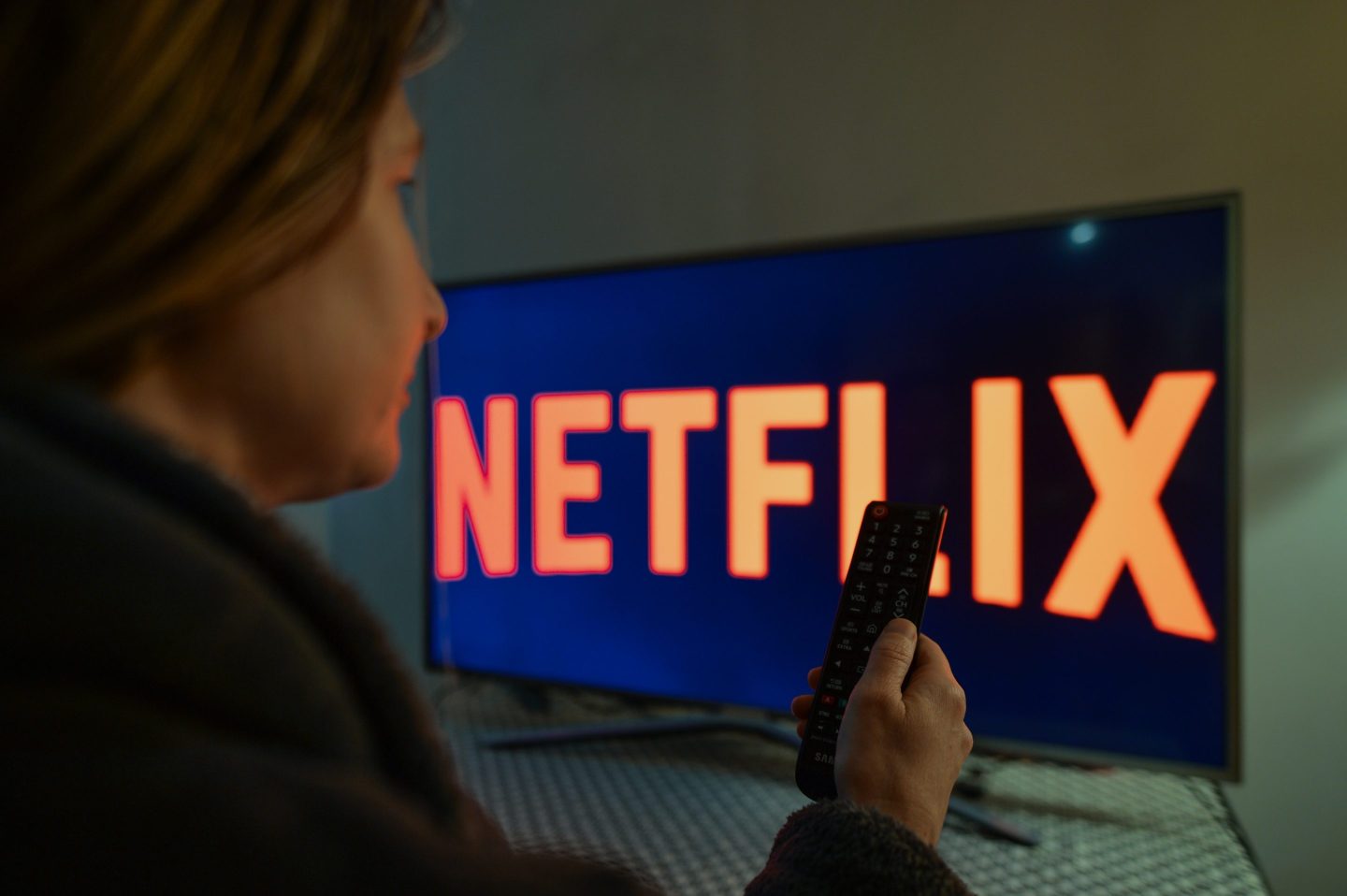A woman watching Netflix on her tv