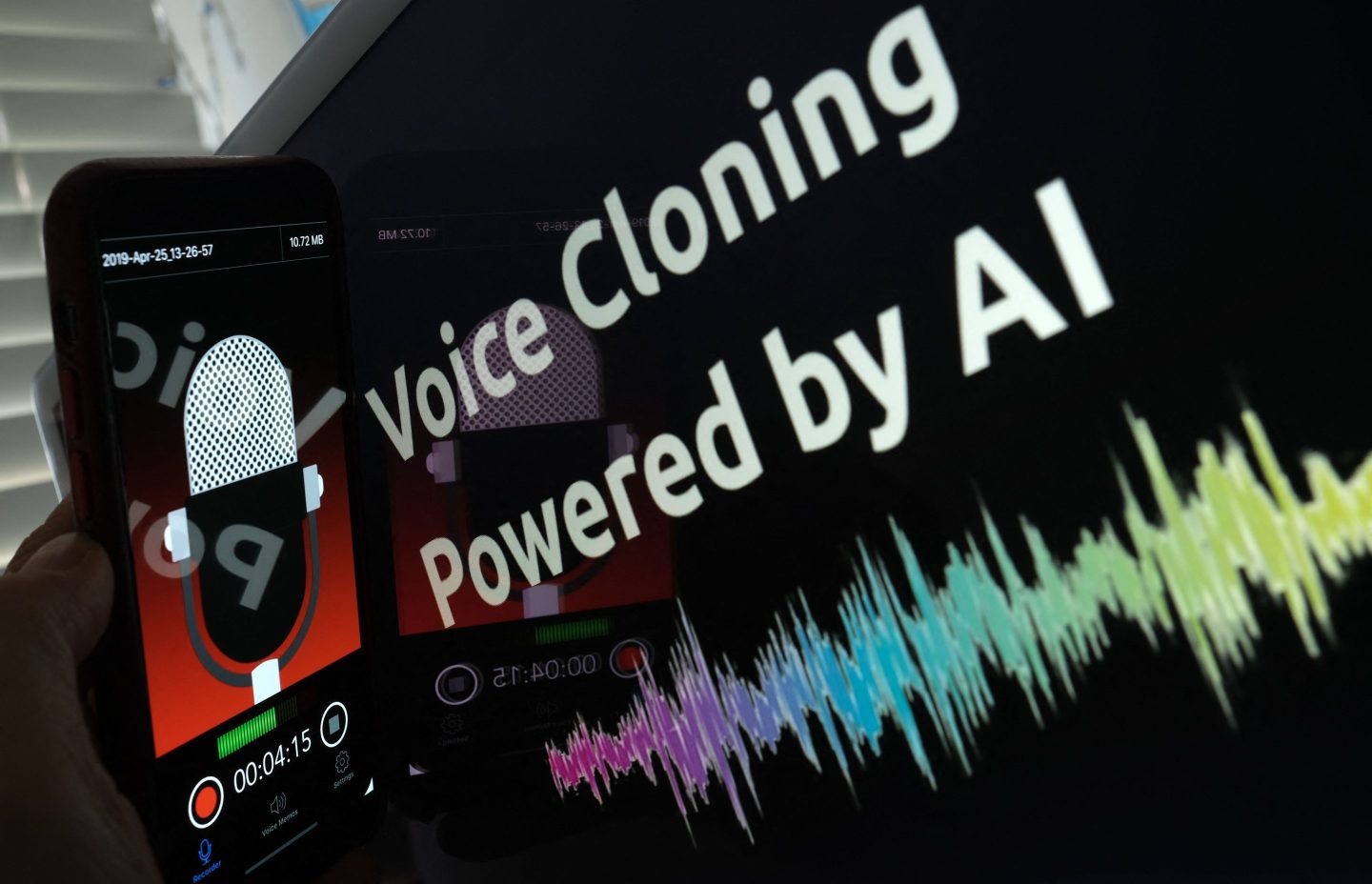 Image of a screen that says "Voice Cloning Powered by AI" and a graph of an audio signal.