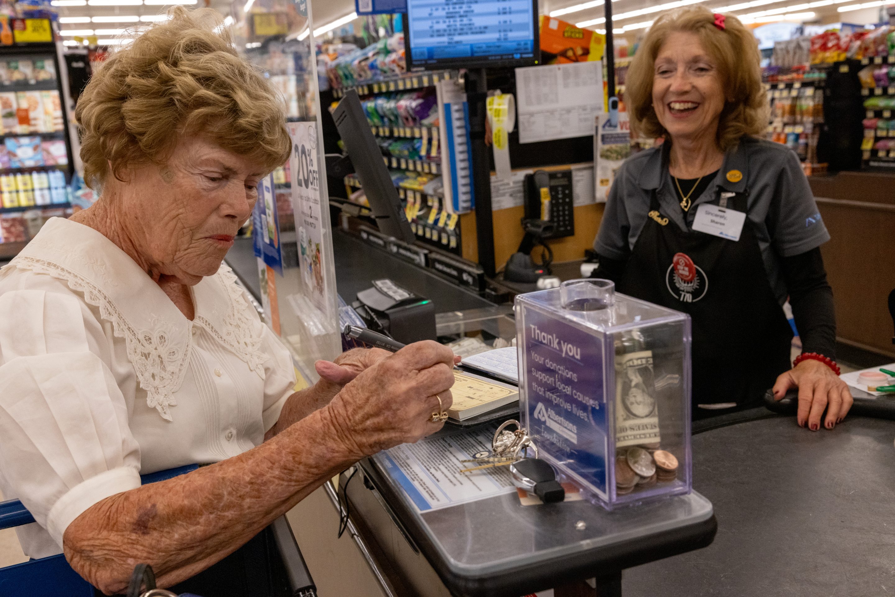 A longtime Albertsons worker chats with a customer at an Irvine, California, store.