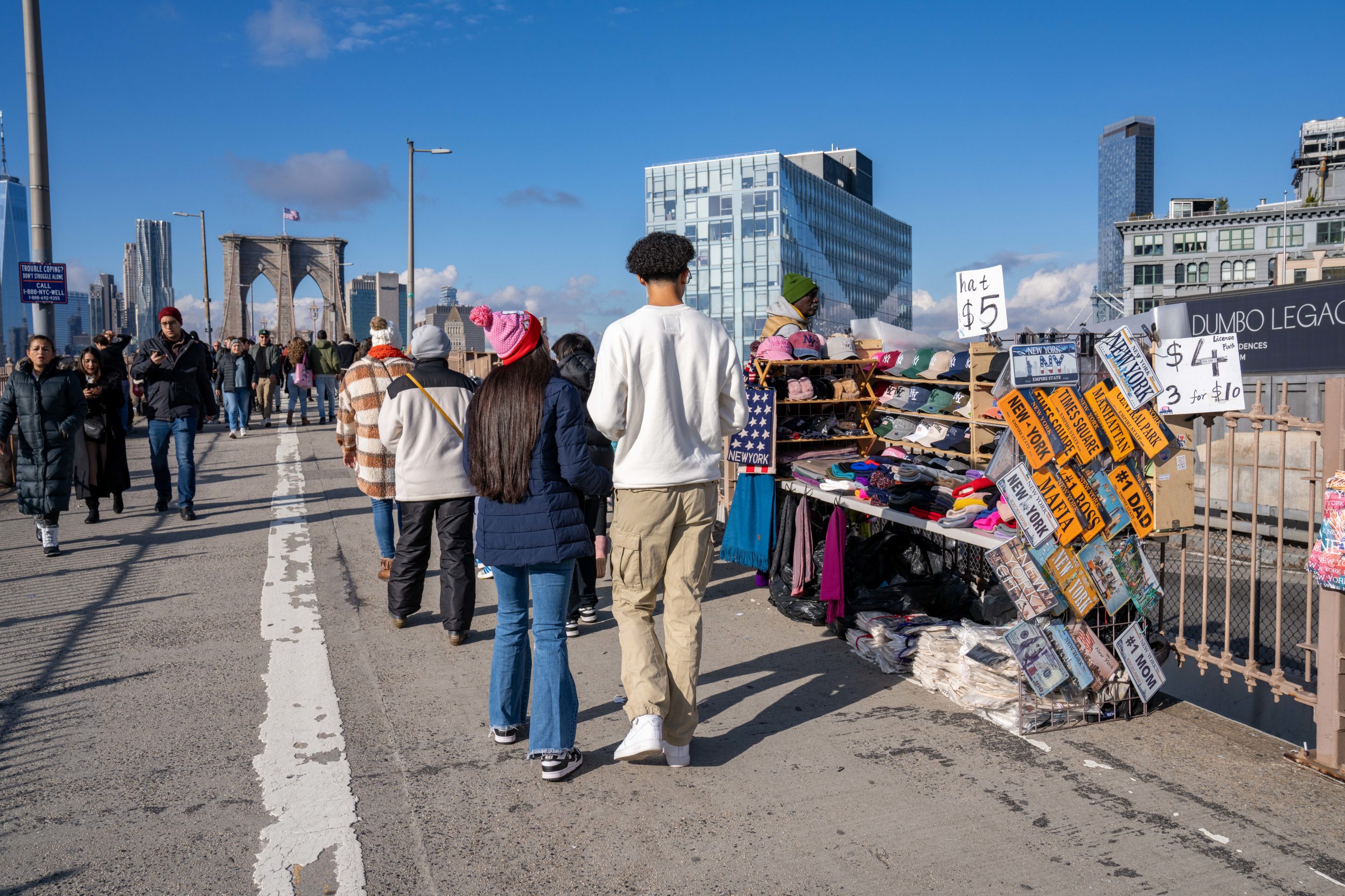 Illegal street vendors and large crowds of people are seen here on the Brooklyn side of the Brooklyn Bridge