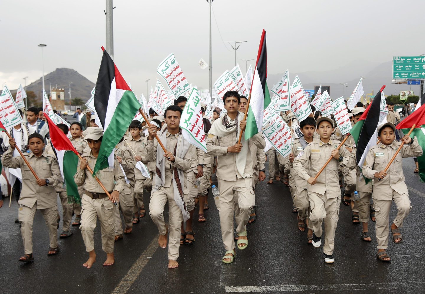 Yemen's Houthi-affiliated boys hold flags of Palestine and the Houthi emblem march during a protest held to condemn the  U.S. for redesignating Houthis as a global terrorist group, and against the U.S.-British aerial attacks conducted on Yemen on January 19, 2024, in Sana'a, Yemen. 