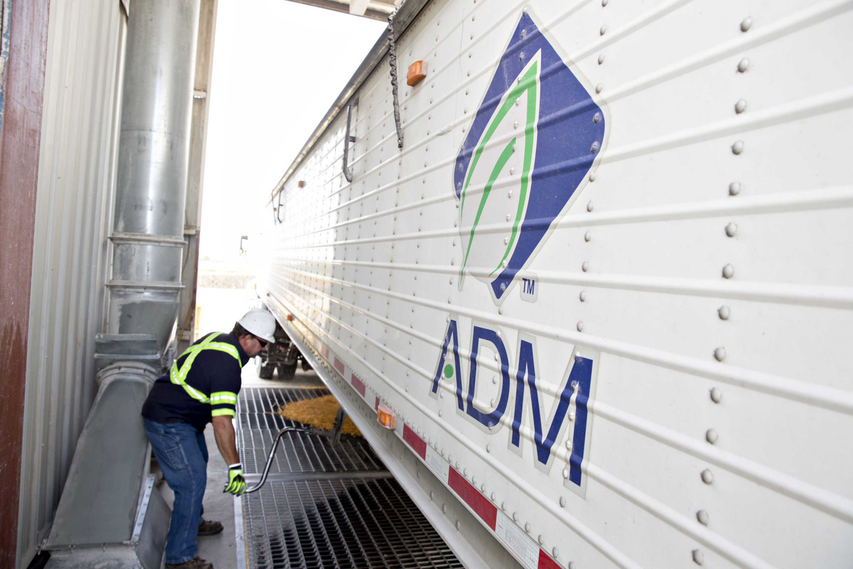 A truck driver opens a hatch to unload corn at the Archer-Daniels-Midland Co. grain facility in Mendota, Illinois, U.S. 