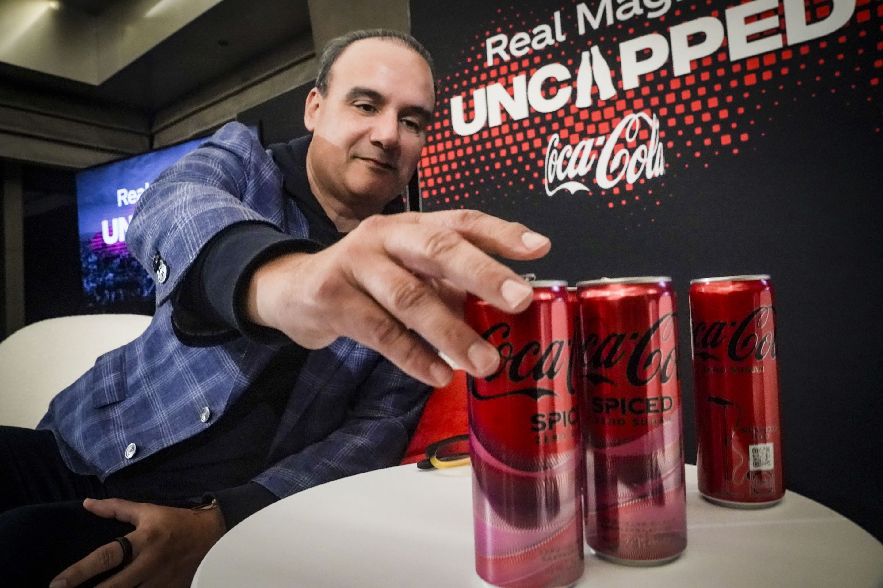 Selman Careaga, president of Coca-Cola's Global Category, reaches for Coca-Cola Spiced, the beverage company's first new offering in North America in three years, on Feb. 6, 2024, in New York.