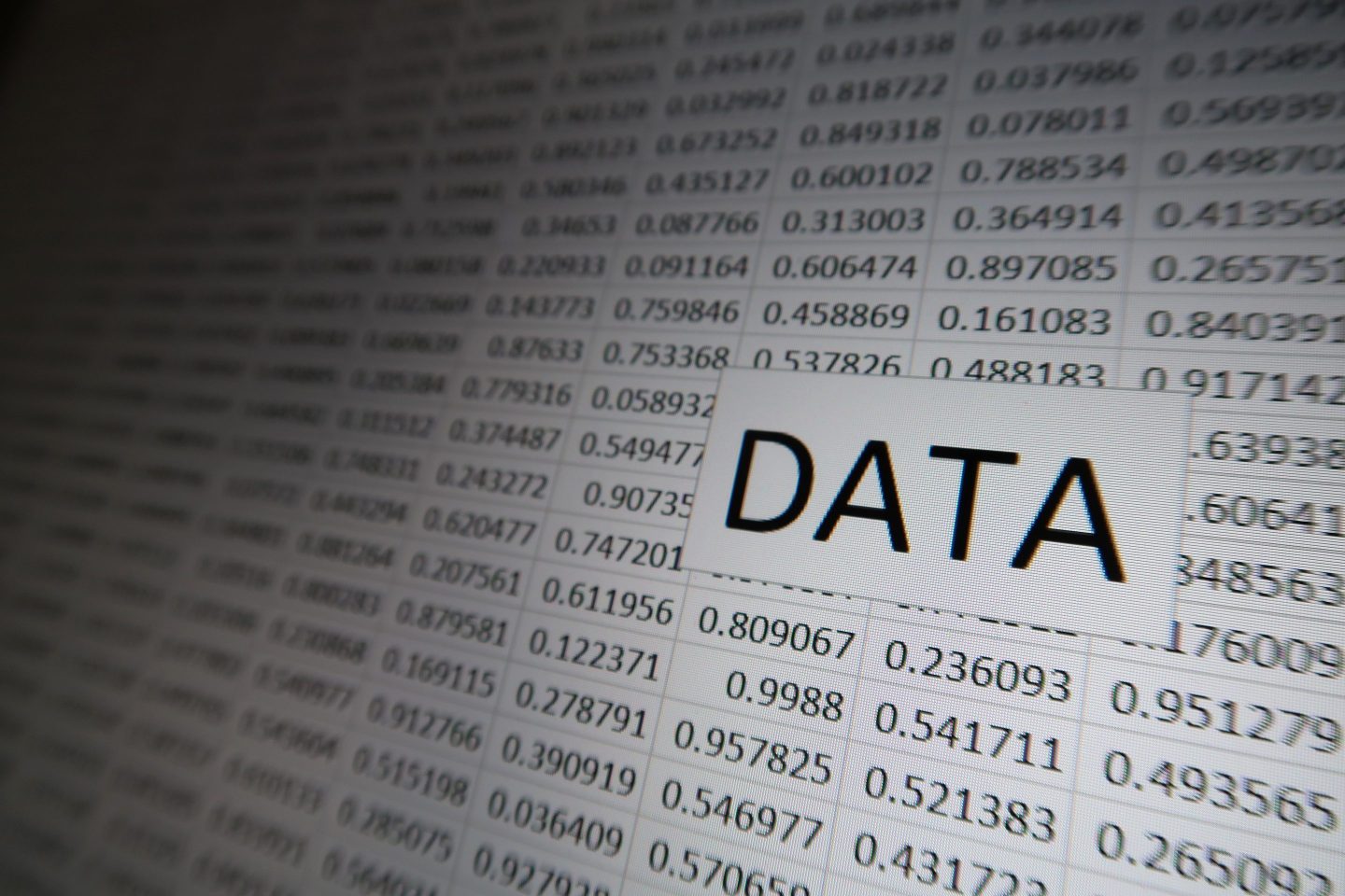 The word "DATA" appears against a grid of random numbers on a digital display