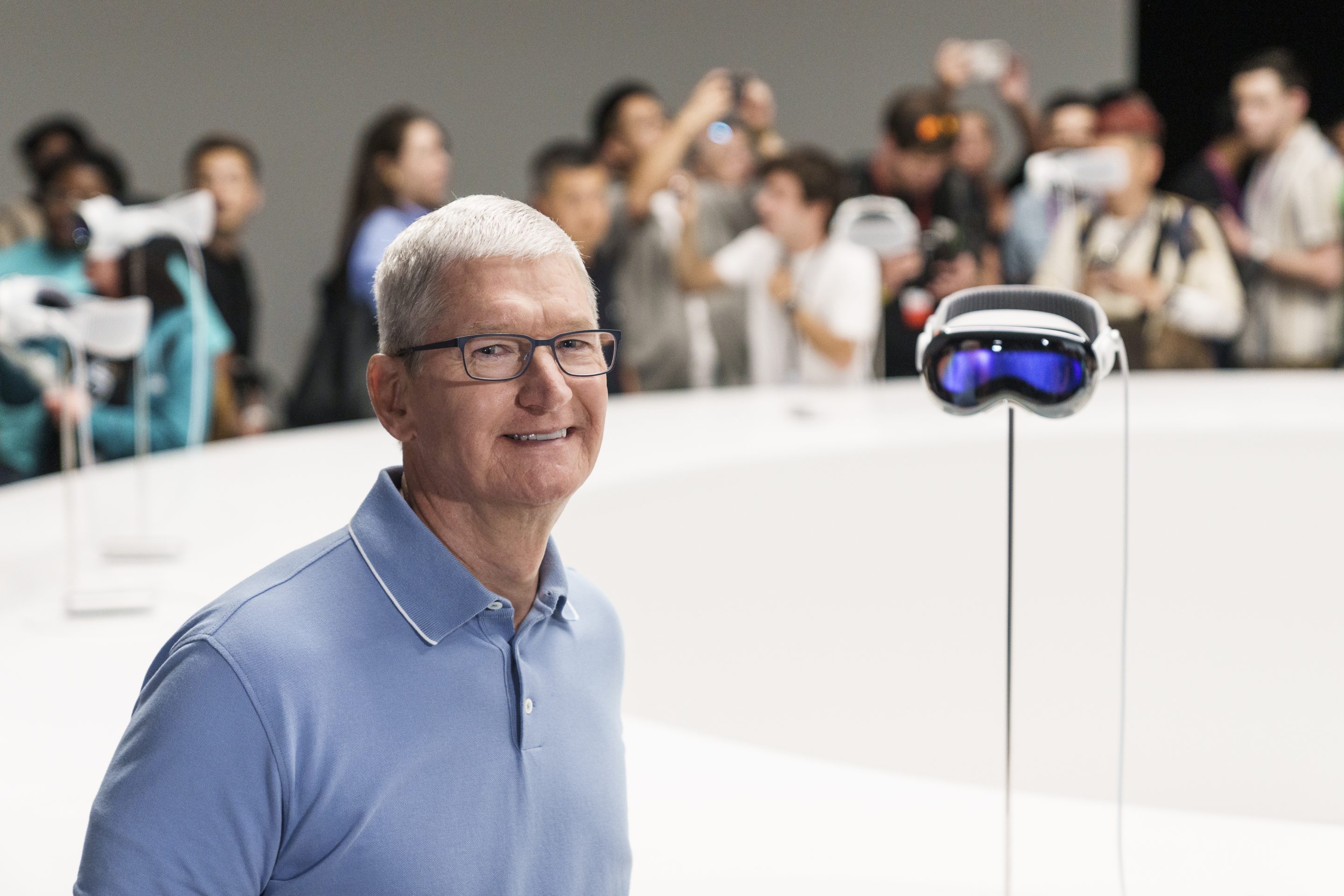 Apple CEO Tim Cook stands beside an Apple Vision Pro headset during the Apple Worldwide Developers Conference in Cupertino in June.